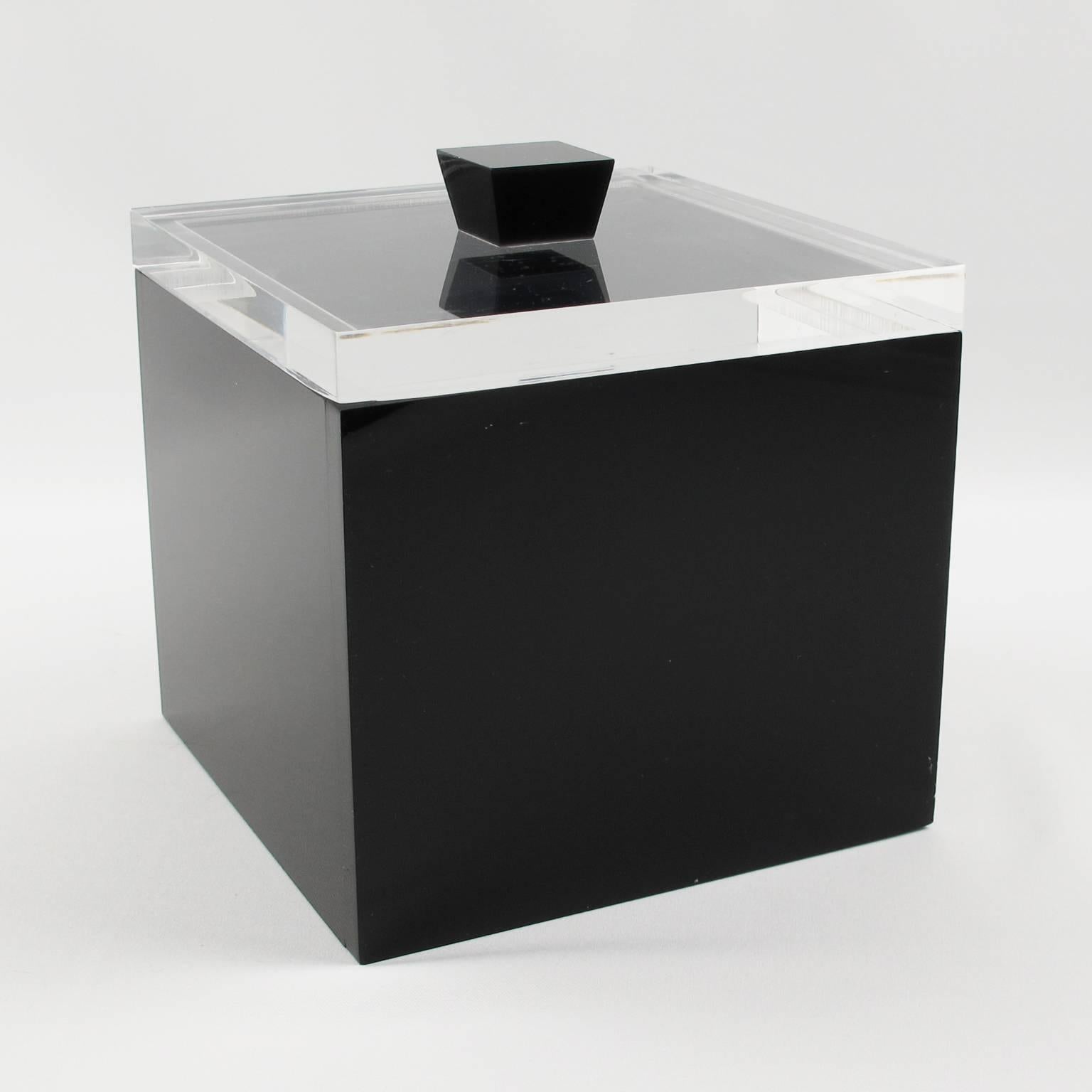 Modernist Lucite ice bucket by Italian designer Alessandro Albrizzi. Vintage, Mid-Century Modern 1970s Lucite geometric ice bucket in crystal clear and black color. Tall square shape with lid.

Measurements: 6.88 in. wide (17.5 cm) x 6.88 in. deep