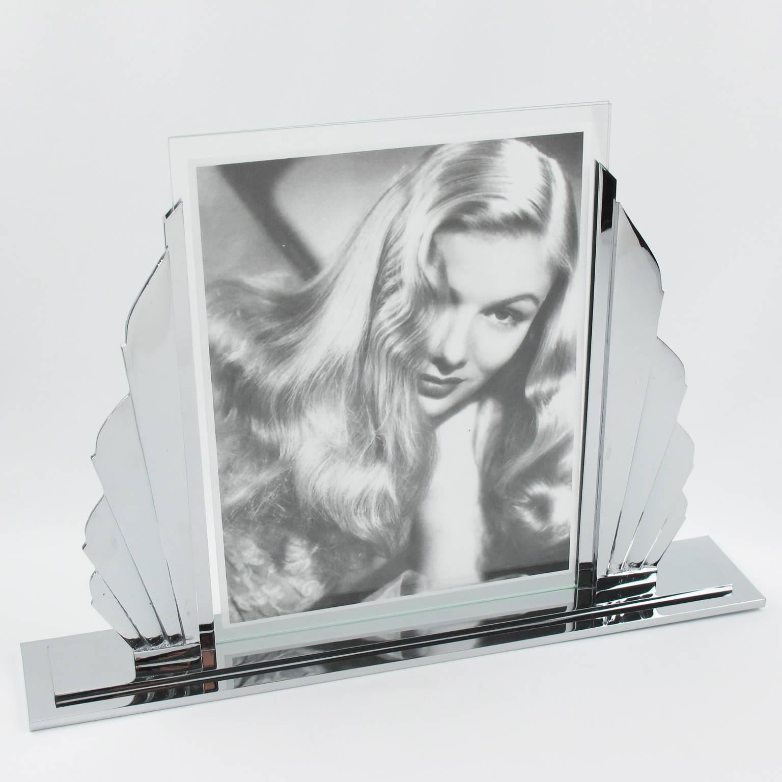 Impressive French Art Deco picture photo frame. Large and heavy quality build with polished chrome featuring a silhouetted stylized sunrise shape with four chrome rays on either side of the picture opening. Large and heavy base in polished chrome as