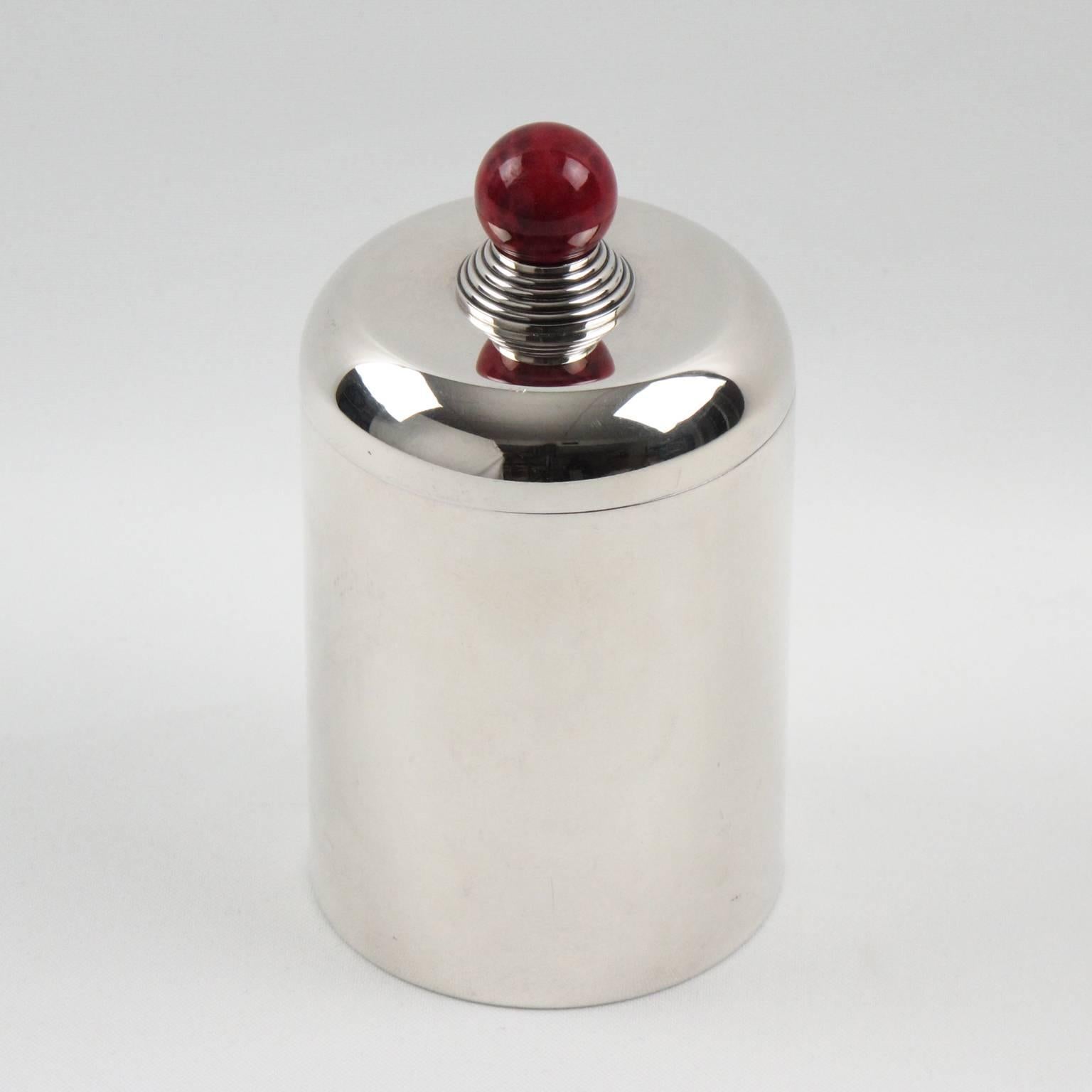 Lovely Art Deco silver plate lidded box by Jean Puiforcat, France, circa 1930s. Minimalist round shape with lid topped with red agate stone finial. Elegant vanity accessory. Hallmark underside 