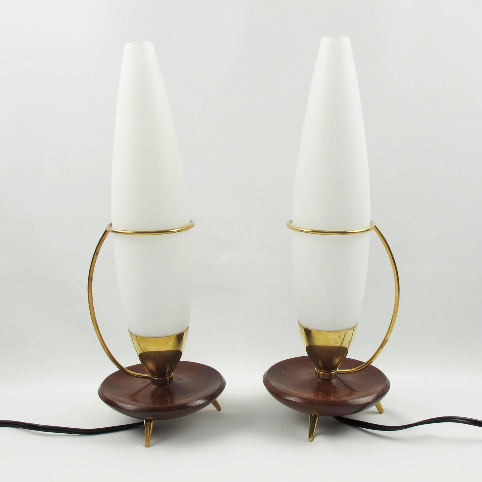 Stunning pair of Mid-Century Modernist Danish table lamps, circa 1950s. Space Age design with Sputnik shape, featuring teak and gilded brass base in a flying saucer shape. Gilded brass holder for original elongated white opaline glass shade. Rewired