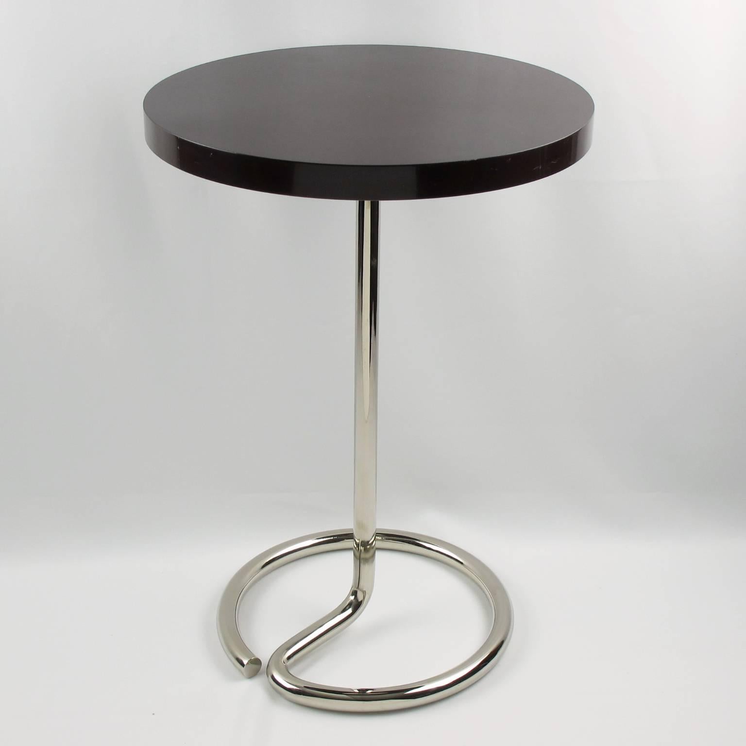 Rare French Art Deco occasional coffee or side table designed by René Herbst, circa 1935s. Minimalist design with original chromed metal snake shape base with black-brown Bakelite round table top. Manufacturers stamps under metal base and under