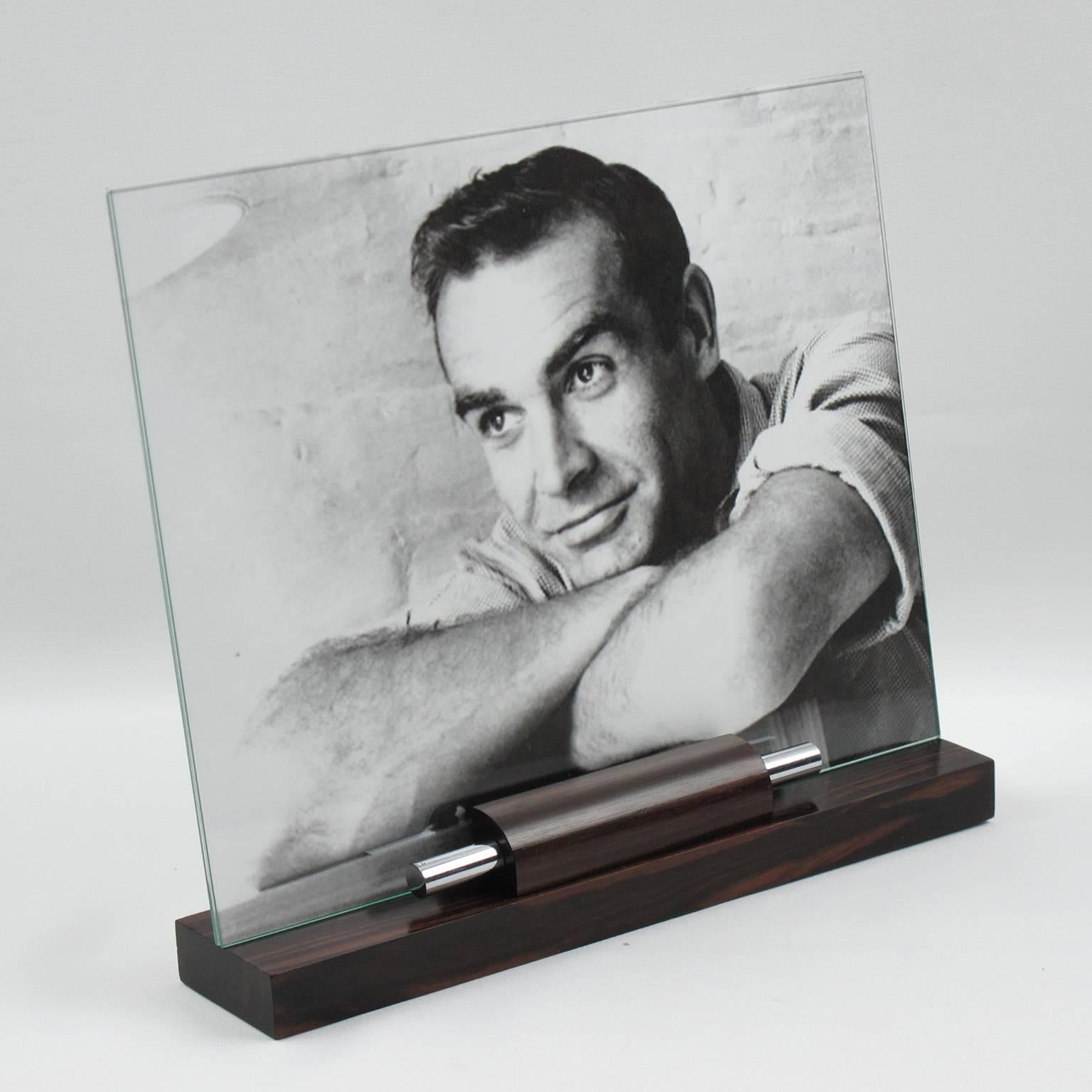Handsome French Art Deco picture photo frame. Featuring thick hand-rubbed Macassar ebony wood plinth compliment with two polished chrome metal rods. The frame is complete with its two glass sheets to enclose the photograph. Please note picture or