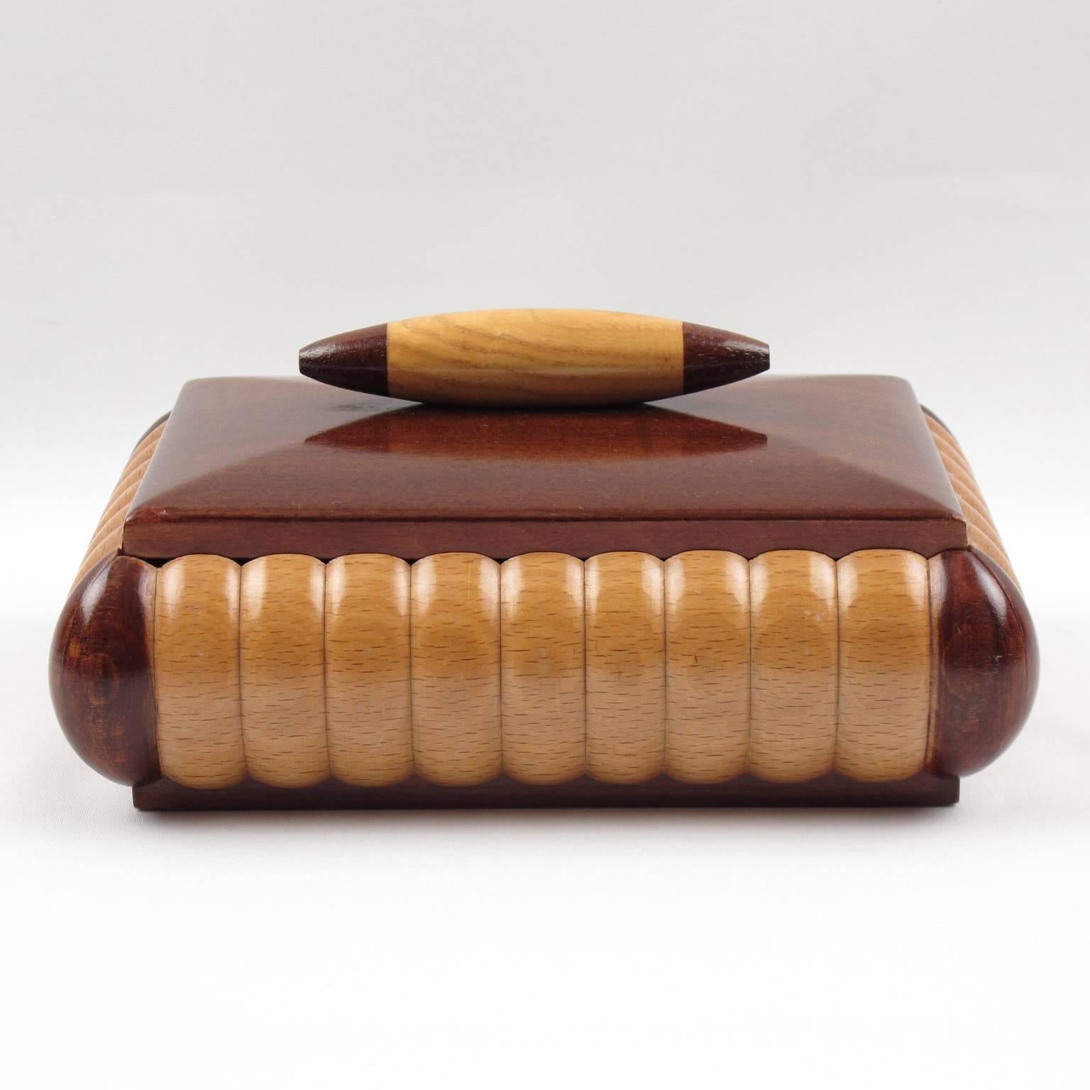 Stunning vintage large decorative lidded box from the French Art Deco period, circa 1940s. Rectangular shape with varnish mahogany and lemon tree wood all carved and shaped. The interior is in natural lemon tree. Mahogany lid with bi-color carved