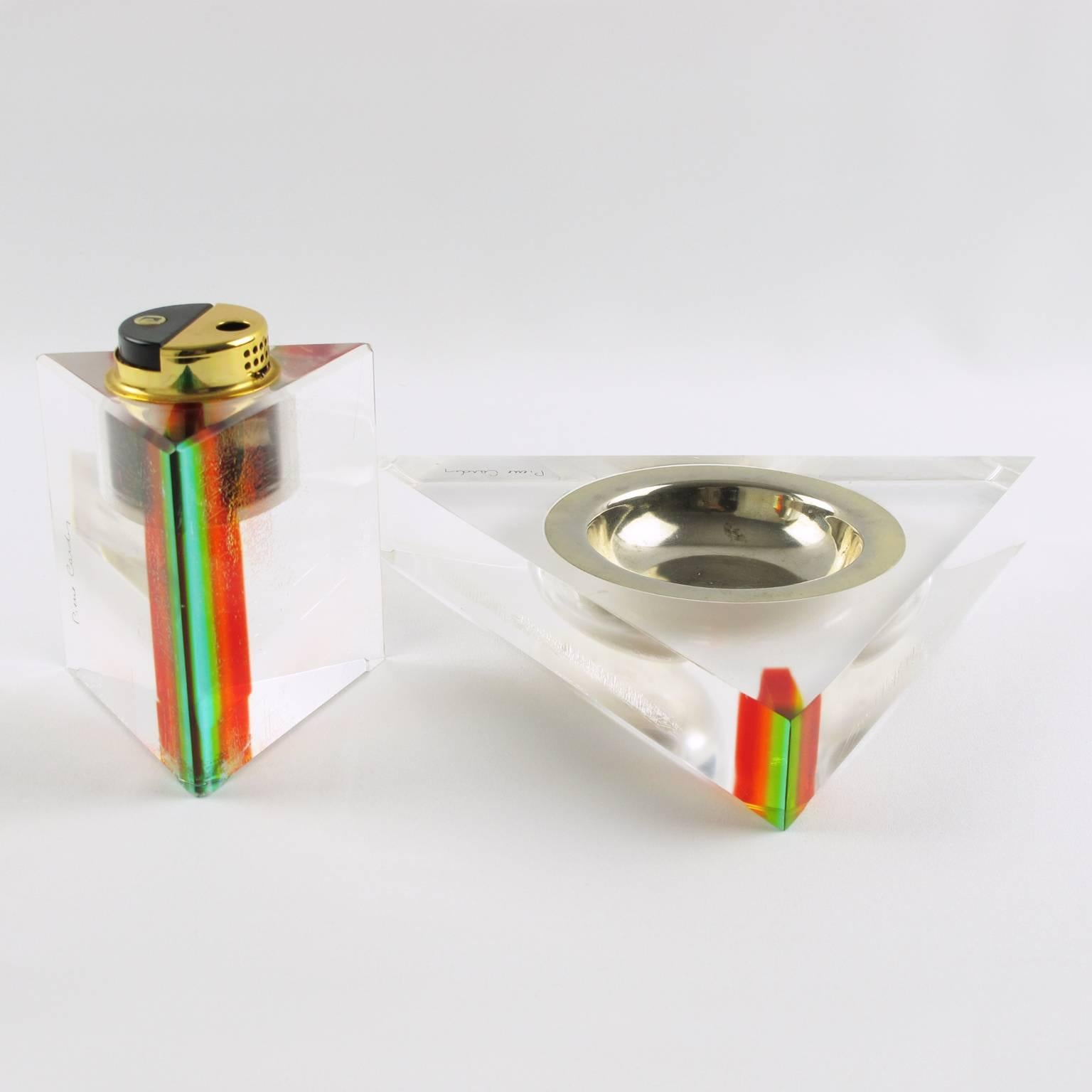 Rare 1970s French designer Pierre Cardin smoking desk set. Featuring ashtray and lighter in crystal clear Lucite with rainbow colors inclusion. Set is build with large geometric ashtray and gas lighter. Each piece is marked: Pierre Cardin with