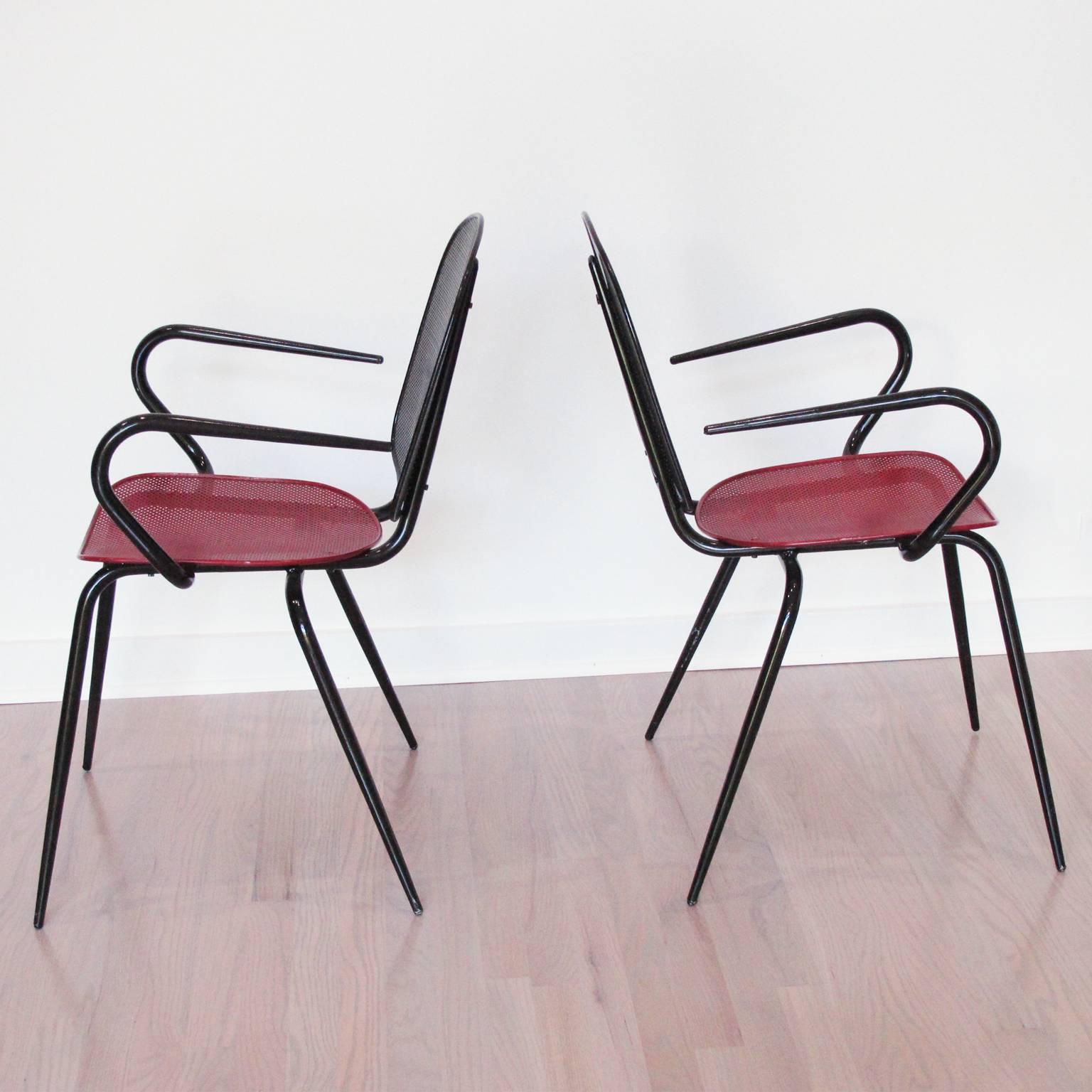 Elegant pair of metal chairs or armchairs designed by Mathieu Matégot. A striking example of French 1950s metalwork. Folded and perforated black and red lacquered metal. Unique design in fine original condition. Manufactured in France, circa 1950s.