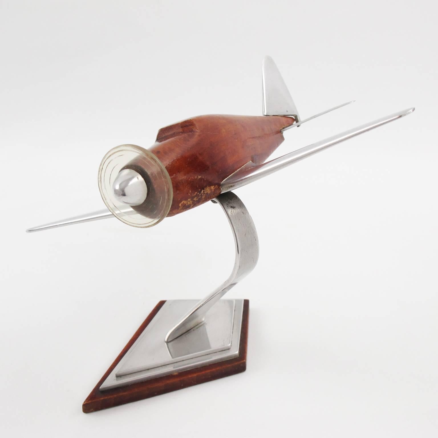 Vintage French Art Deco wood and cast aluminium airplane model, mounted on a stylized plinth. This nice Art Deco model airplane is made with solid varnish wood and cast aluminium. It has one Lucite propeller. Standing on a geometric wood and