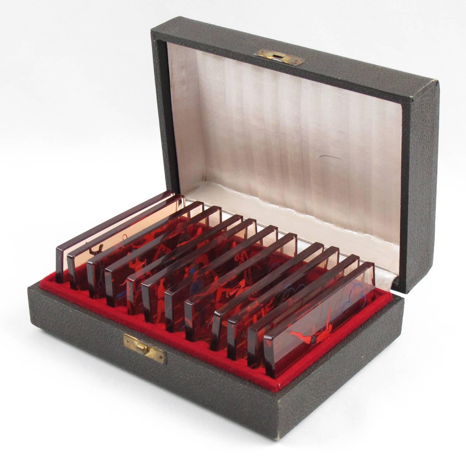 Extremely rare complete knife rests set (12 pieces), in original box, France, circa 1930s. Gorgeous thick copper glass slab knife rests set with reverse etched design and paint application. Highly collectible sport memorabilia, each knife rest has a