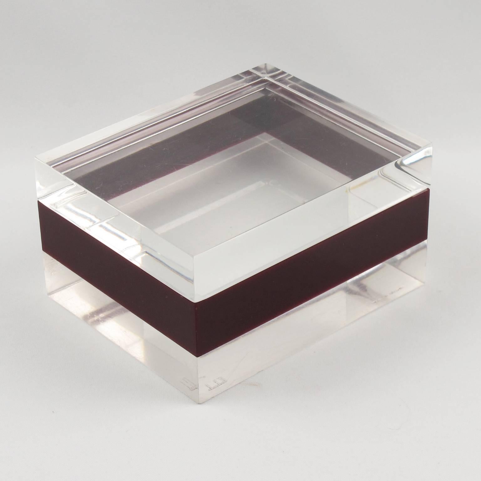 Rare Mid-Century modernist Lucite decorative box by Dunhill, England, circa 1970s. Crystal clear and cranberry red color, geometric rectangular shape, gorgeous design. Marked underside: Dunhill - Made in England. 

Measurements: 4.5 in. wide (11 cm)