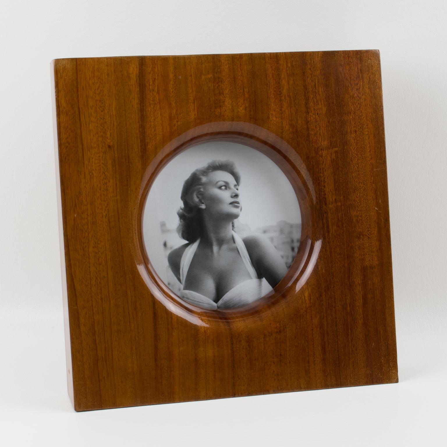 Emanuele Pantanella (1939-2014), an Italian designer, created this sumptuous picture frame circa 1980. The rare piece boasts a solid, tropical-wood carved construction with a high-gloss, polished finish in a minimalist, geometric shape. Emanuele