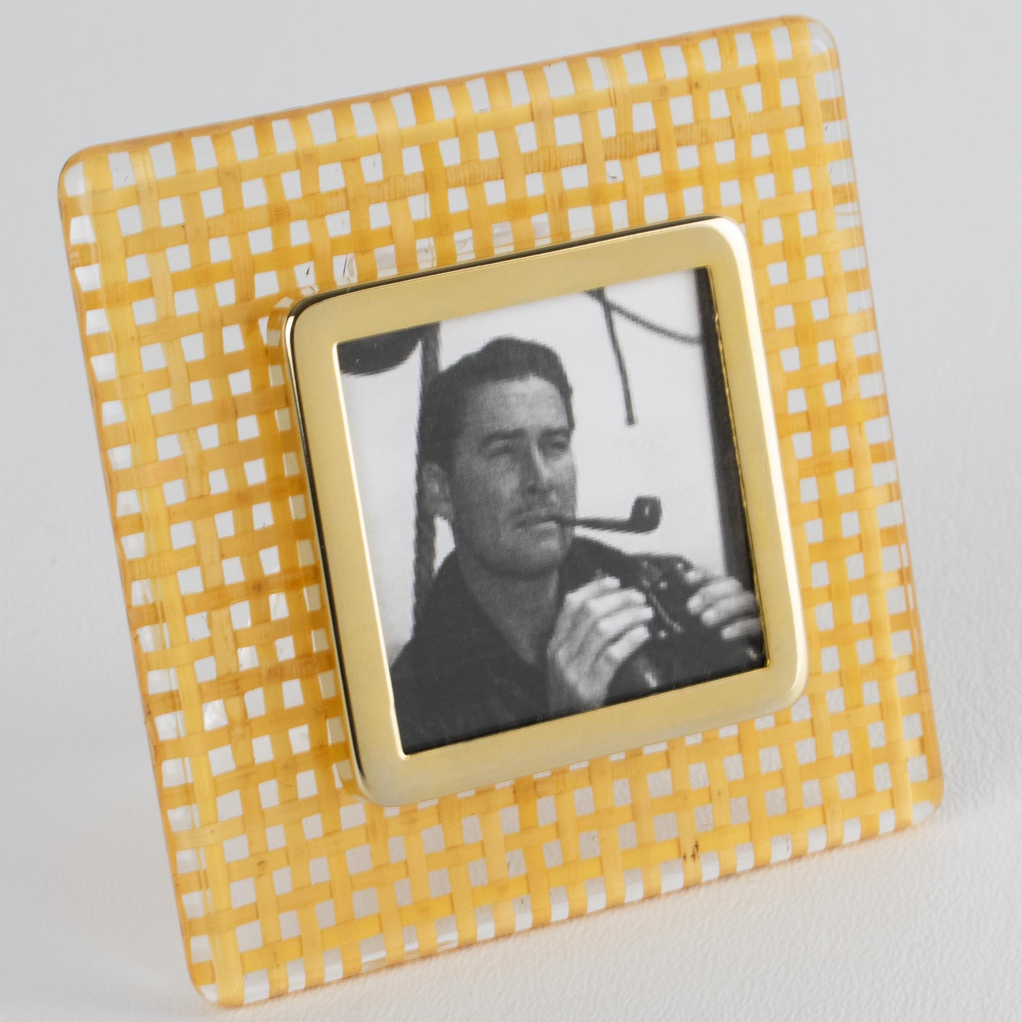 This stunning decorative picture frame is perfect for a living space or vanity. The photo frame features a square shape with clear acrylic Lucite and rattan or wicker cane work. Genuine natural rattan has been blended into the Lucite material. The