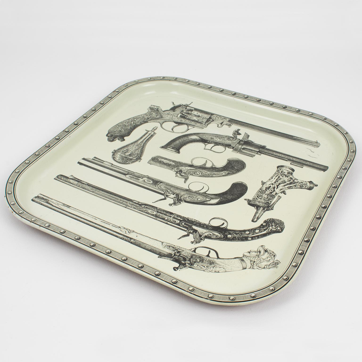 This is a stunning Italian studio barware serving tray. The rare piece was crafted in Italy circa 1960. The stylishly decorative enamel square metal tray features a quirky and cool print of antique pistols, guns, and powder pouches. The underside