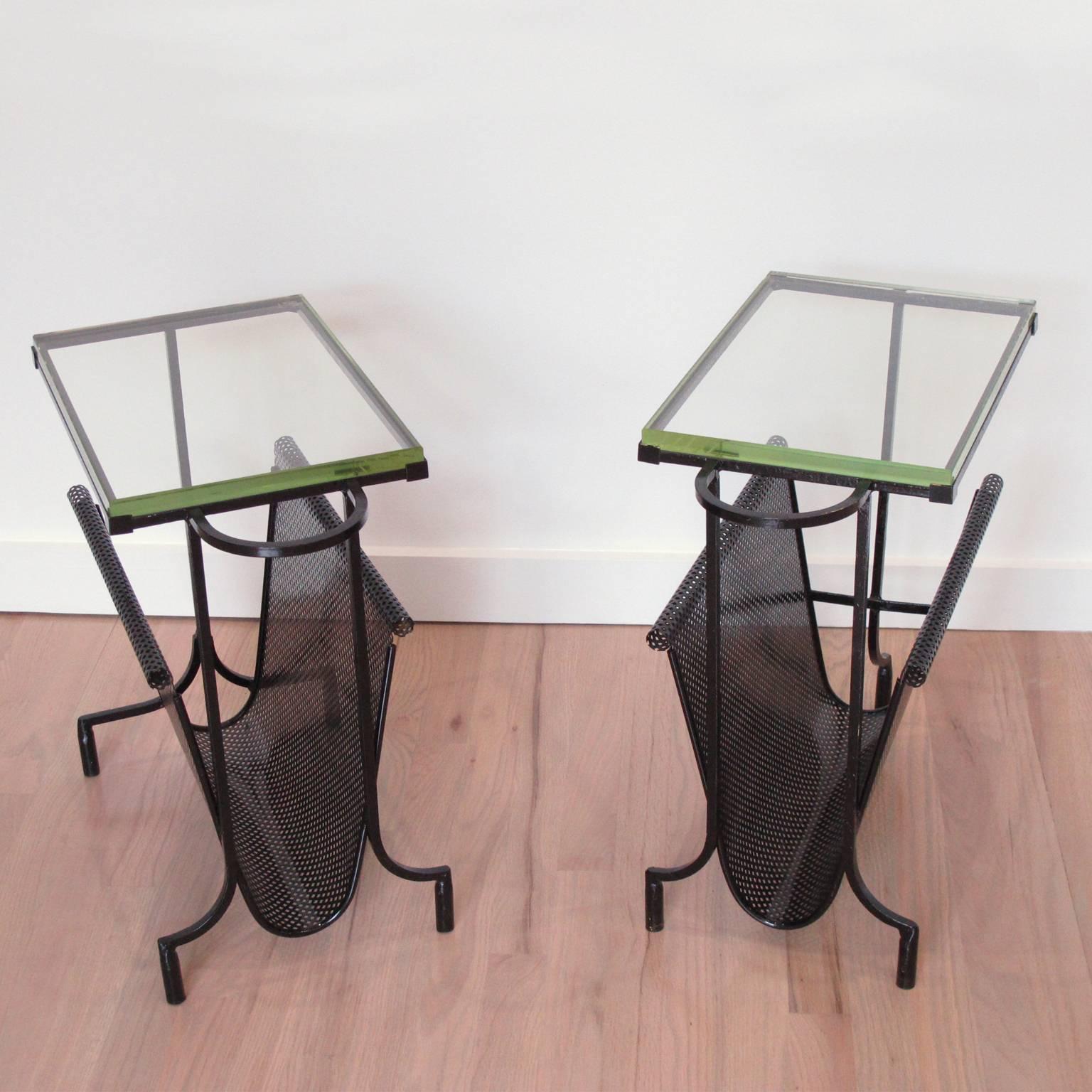 Stunning vintage 1950s pair of perforated metal and glass magazine stand or side table, by French designer Mathieu Matégot. Original black lacquered patina with original Saint Gobain thick glass slab table top. Perfect to use for magazines or books