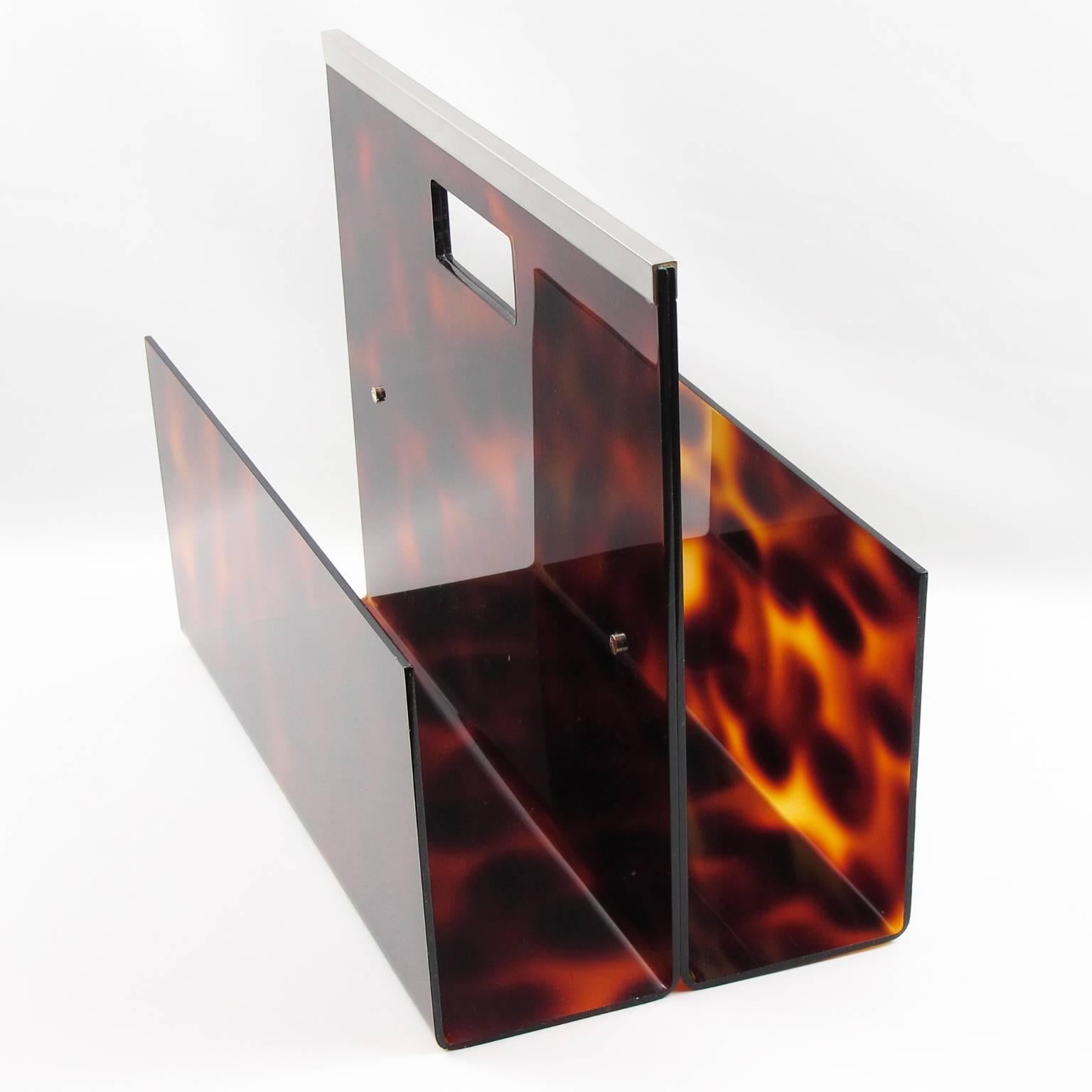 Stunning Mid-Century Modern magazine rack, holder, stand made of Lucite and chrome designed for Christian Dior Home collection in 1970s. Geometric shape with chromed metal gallery and faux tortoiseshell textured pattern Lucite. Great accessory for