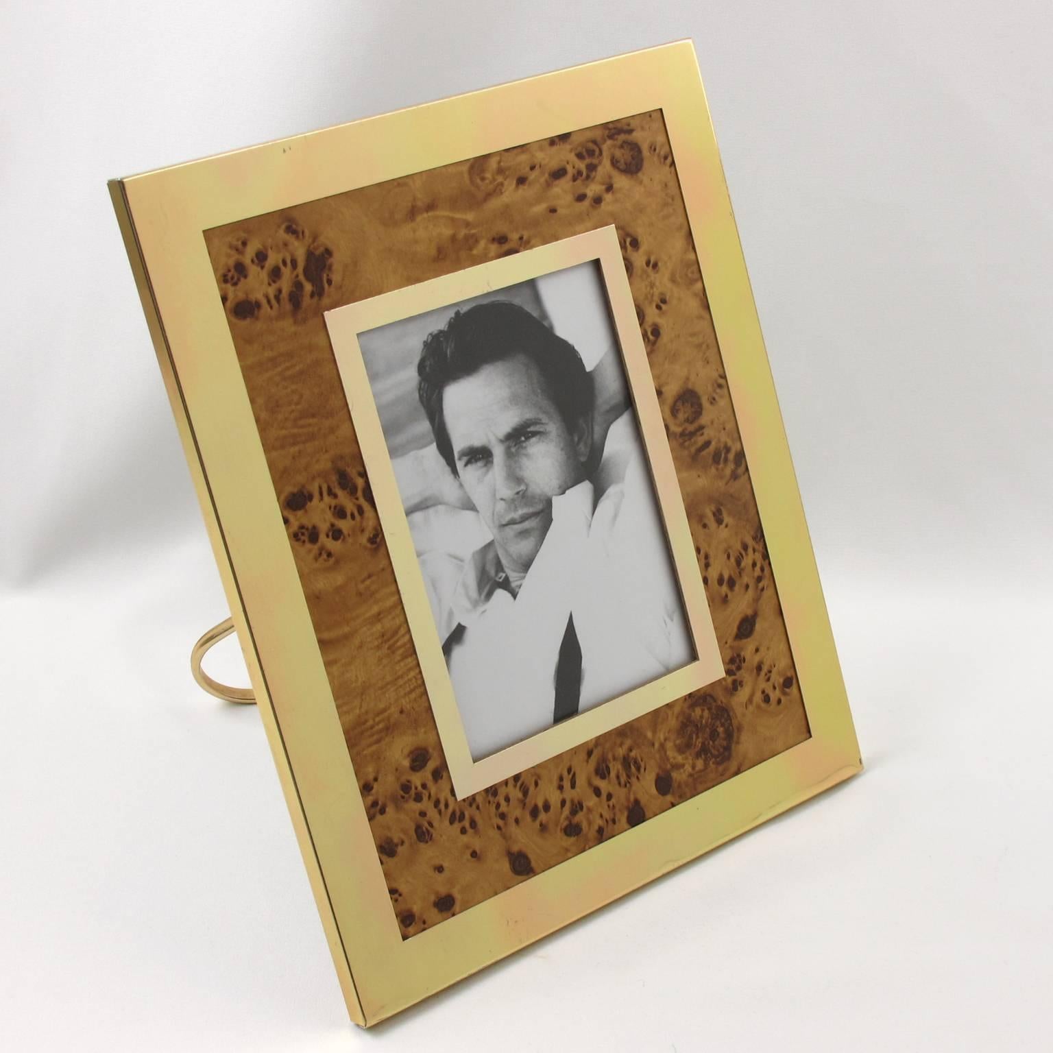 Lovely vintage Mid-Century Modern picture photo frame in the style of Willy Rizzo, circa 1970s. Gilded aluminum and formica imitating bird's eye maple wood. Metal easel at the back. Excellent vintage condition.

Measurements:
Overall 8.50 in. wide