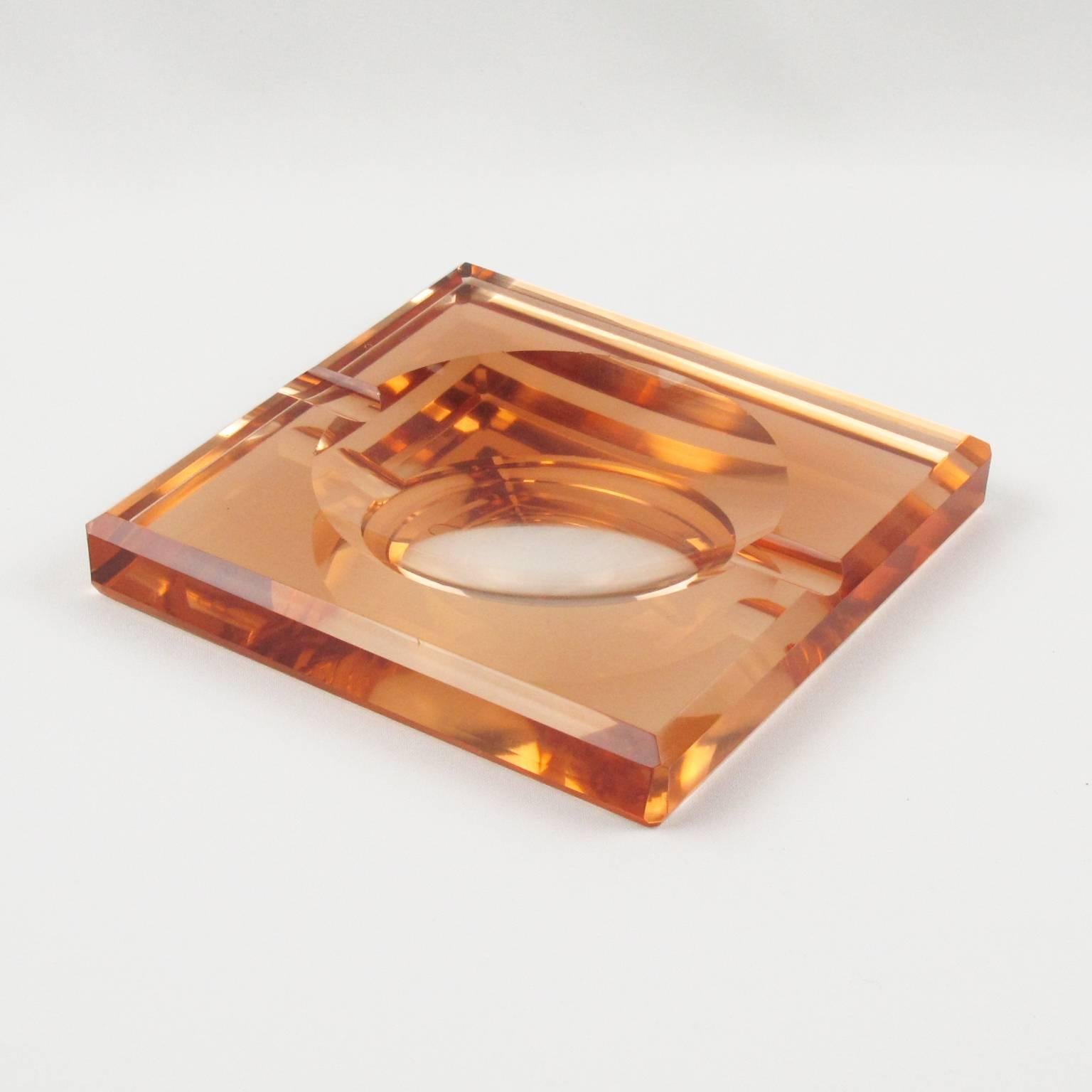 Rare Art Deco mirrored cigar ashtray or desk tidy or vide-poche by French designer Jean Luce, circa 1930s. Square shape with thick copper or peach mirrored glass slab with sanded and polished round motif in the centre with deep bevelling all around.