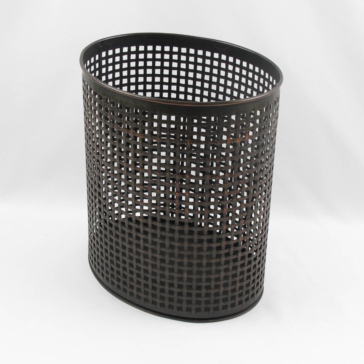 Vintage Mid-Century Modernist perforated metal industrial desk accessory waste basket in the manner of Mathieu Mategot. A striking example of French 1950s metalwork. Folded, perforated metal with plaiting pattern. Fine original condition with dark
