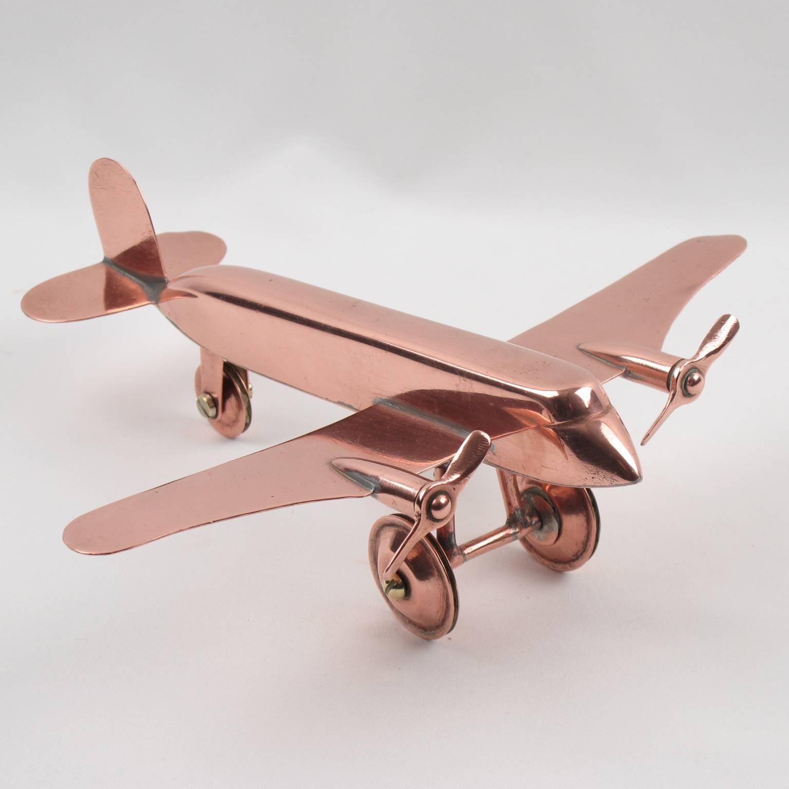 Rare stunning French copper airplane model. It is a small scale airplane with intricate details and looks great displayed on a desk. Two copper propellers in rotating condition. Model stands on its wheels in working condition. No visible marking.