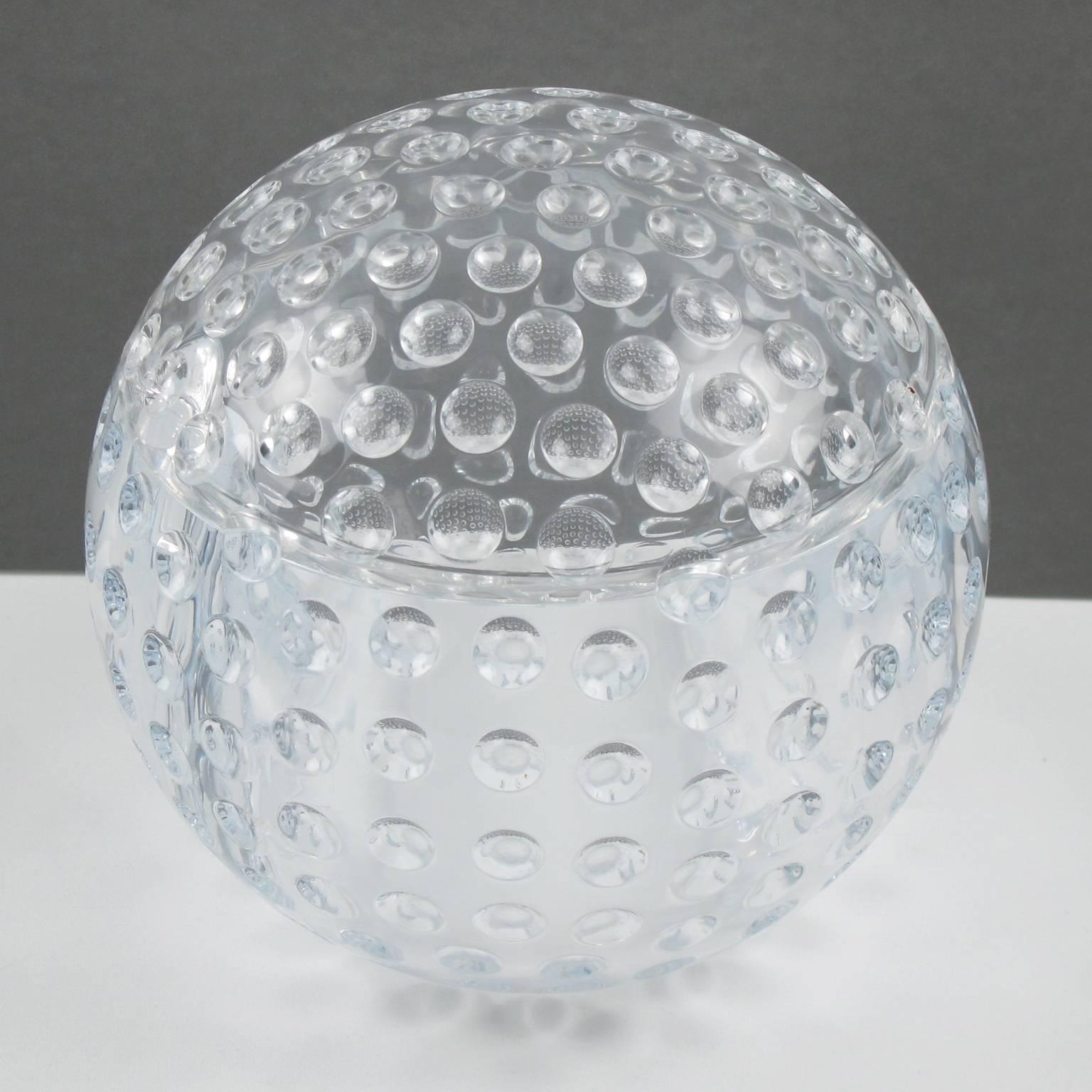 Stunning modernist Lucite centerpiece or ice bucket with swivel top. Sculptural crystal clear Lucite featuring a gigantic golf ball with bubbles carving all around. The top swivels to reveal a large space perfect for ice or for candy. Awesome