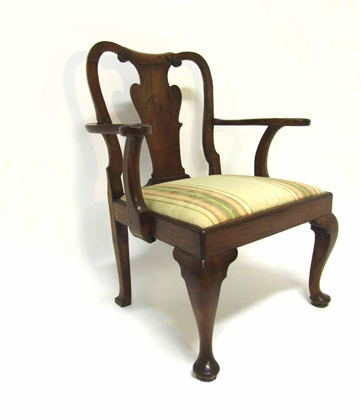 Fine antique George I period walnut armchair; rolled scroll crest rail flanked by C-scrolled, vasi-form back splat, flanked by carved side arms with shell and foliate hand grips slip seat and raised on cabriole legs ending in skippered pad feet.