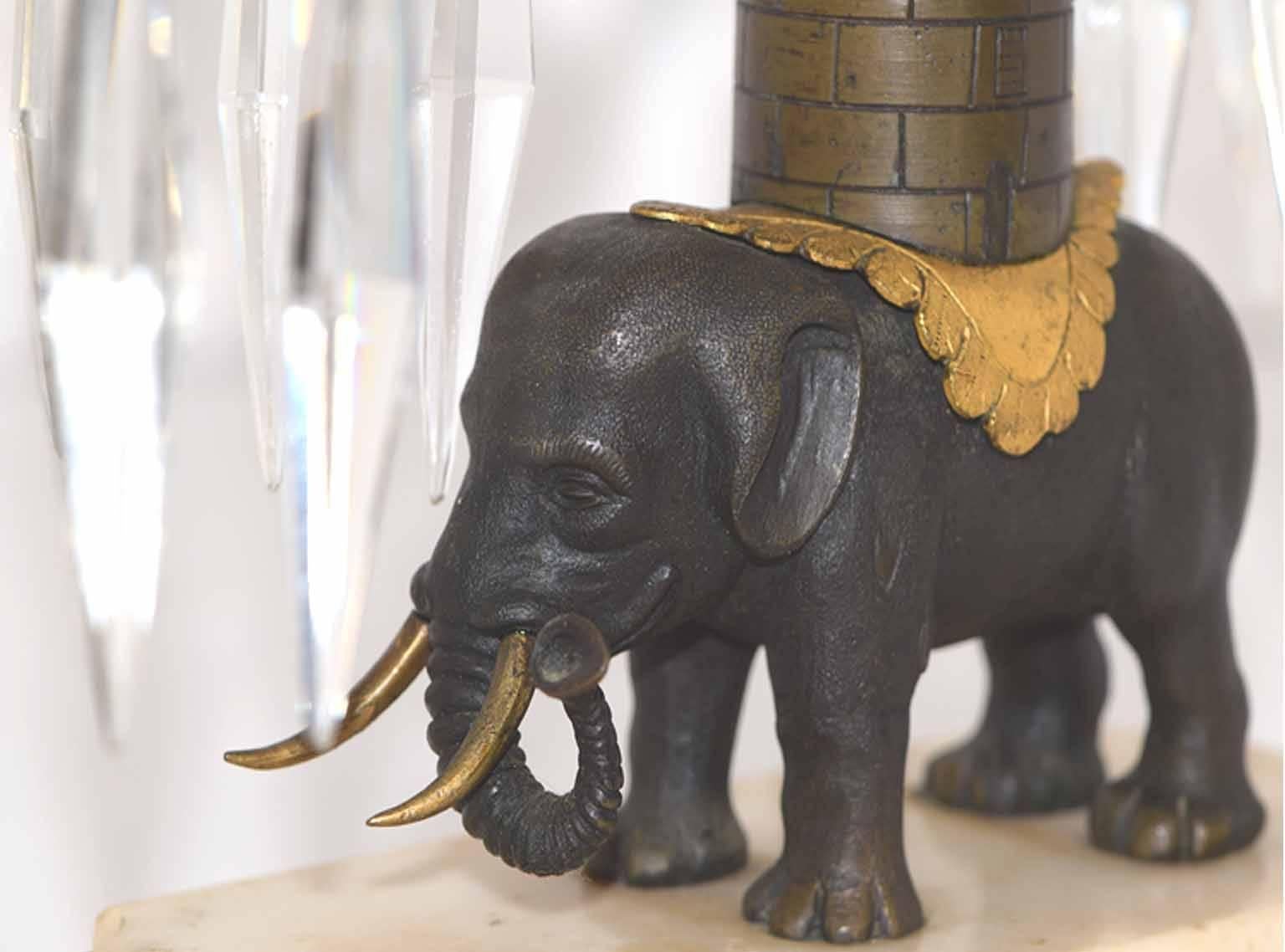Pair of antique English George III Regency period cut crystal, bronze and marble girandoles the gilt bronze candle arms and central crystal flame finial borne atop an elephant figure and crenelated castle tower, raised on gray and white shaped