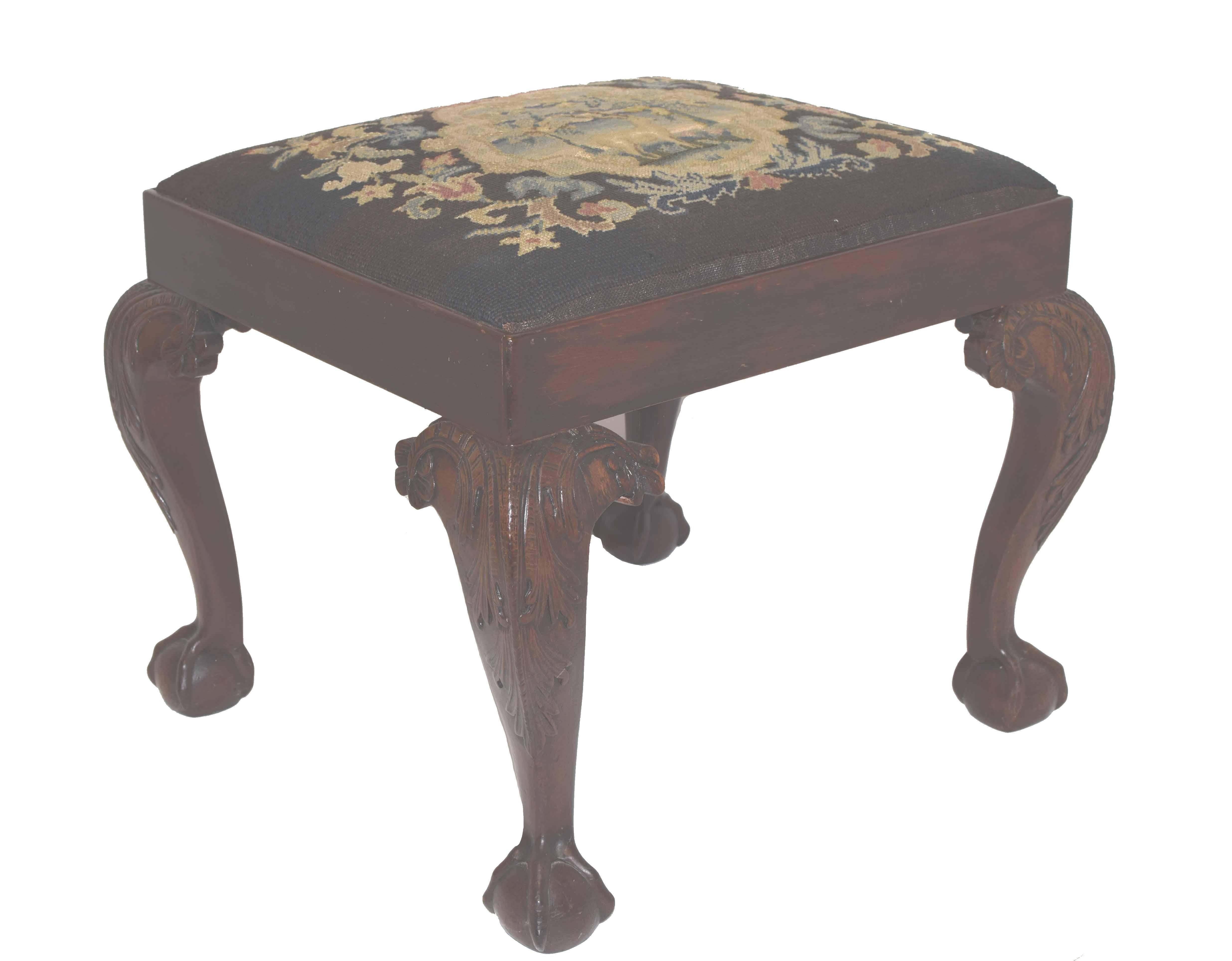 Antique bench with a rectangular needlepoint slip seat above a plain apron, raised on four cabriole legs carved at the knees with acanthus and floral and ending in claw and ball feet, circa 1760.