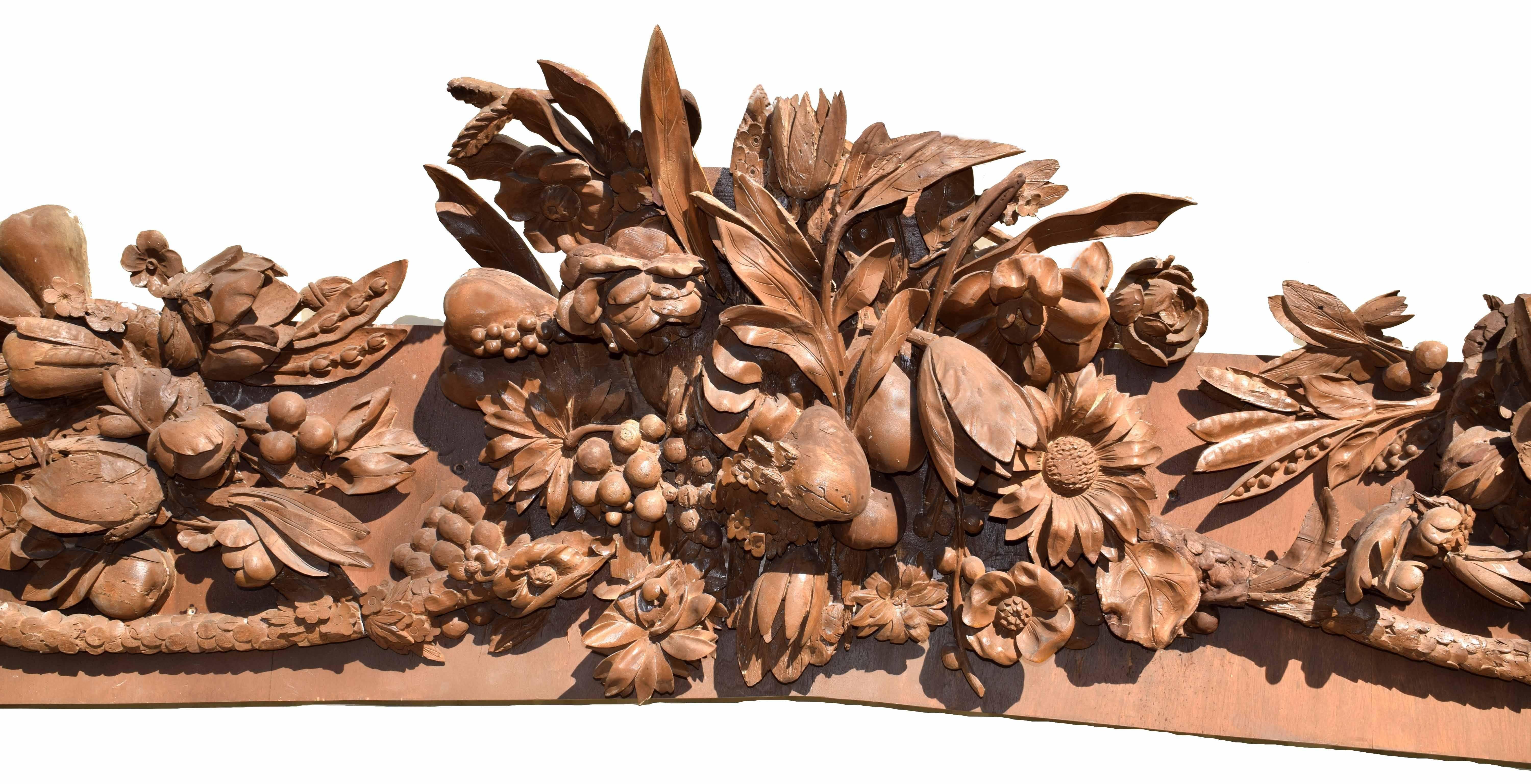 Antique English 18th century carved lime-wood swag in the style of Grinling Gibbons; the central cartouche formed of summer's harvest in floral, fruit and grain with grapes, melon, wheat, peapods berries, etc., flanked by pendants of barley springs,