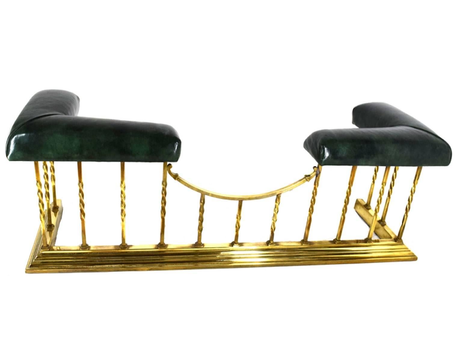 Antique English club fender of rectangular form, with two L-form leather upholstered seats flanking, raised on apical brass columns, centered by a concave member, supported upon a stepped base, circa 1870.