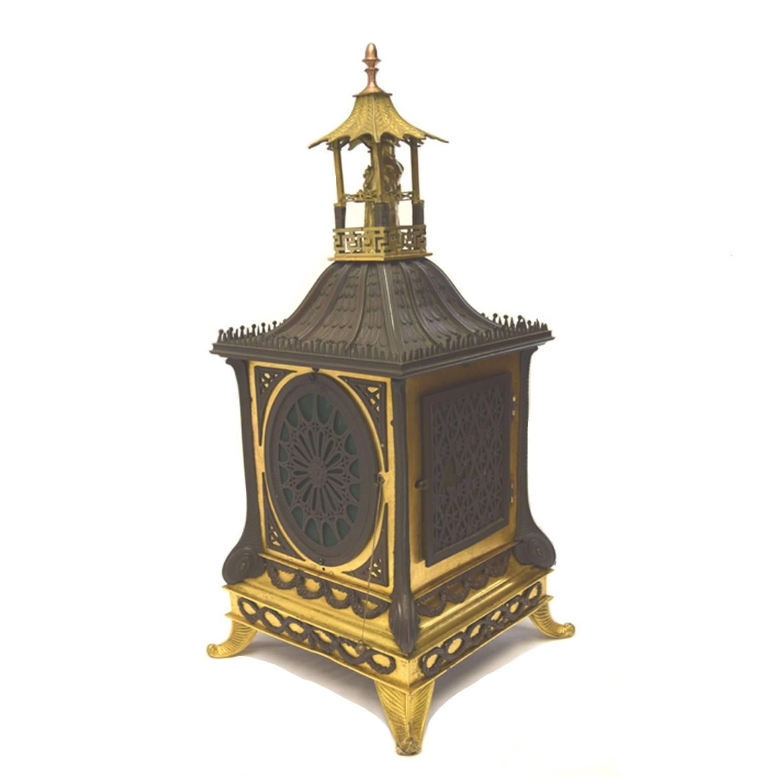 Antique English bronze bracket clock by J & A. Jump I Old Bond Street, London, repeater, silvered dial, the neoclassical architectonic case modeled as a Chinese pagoda, with mandarin finial, striking two bells on scroll feet, circa 1845.