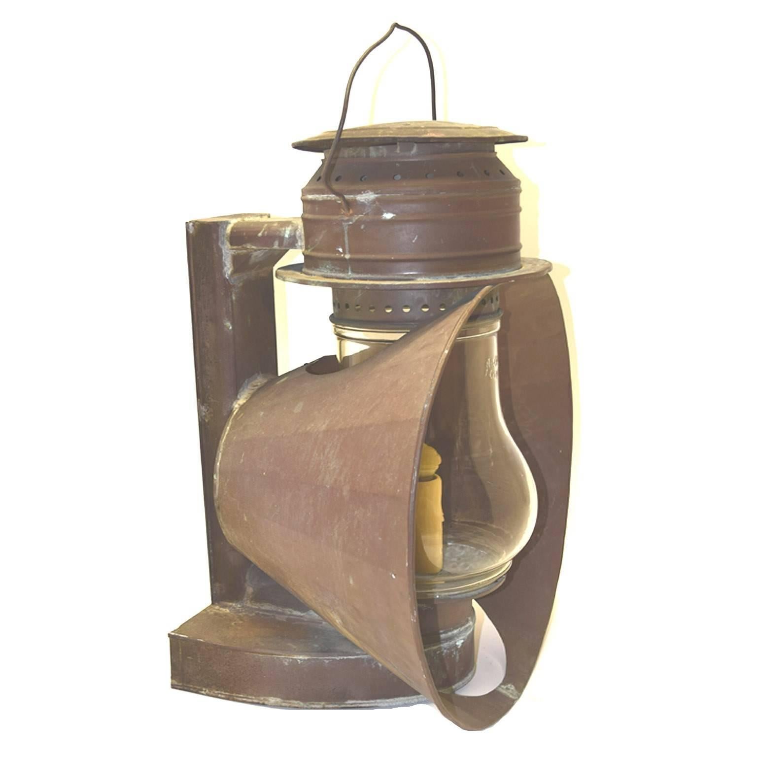 Antique American copper ship lanterns, with swing handles, cylindrical glass chimneys, replacements, circular multisided and faceted tapering reflectors, later candle wired, circa 1890-1910.