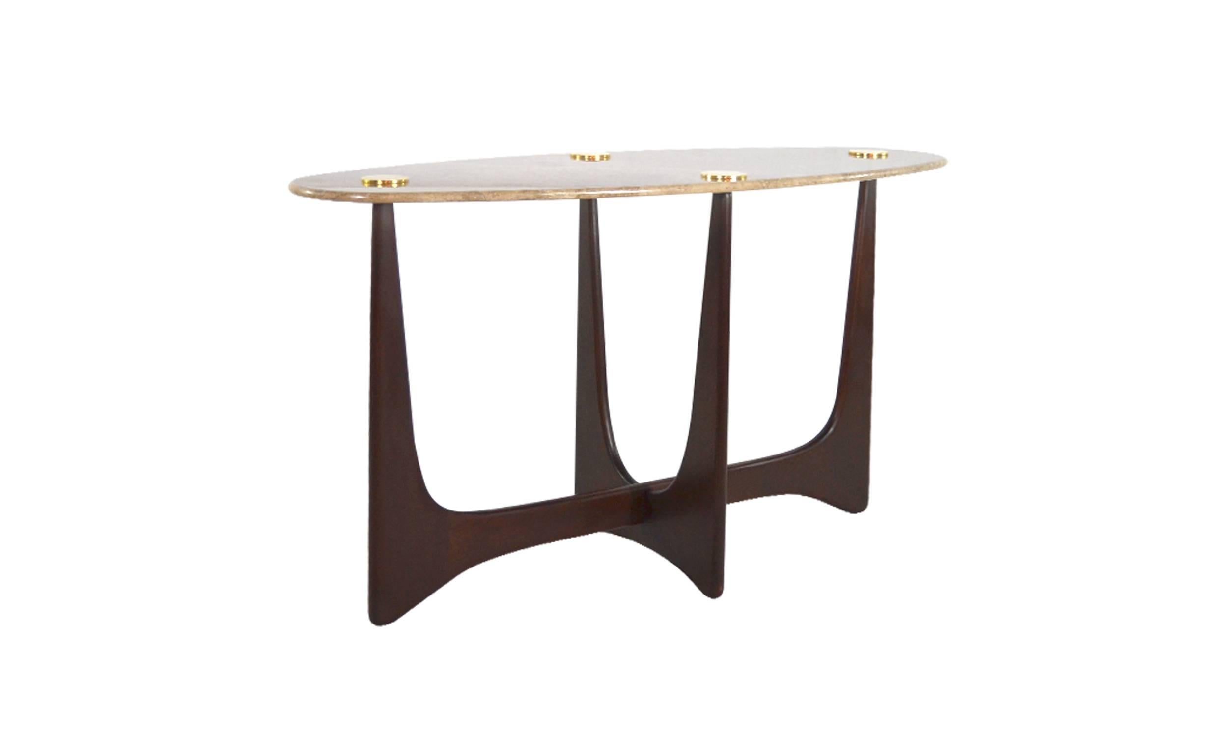 The "Opalo" console is a light and airy yet very strong piece of furniture supported by a hand-sculpted walnut base stained in a medium tone.
For a top we've chosen an oval shaped bull-nosed edge marble-top, highlighted and fastened in