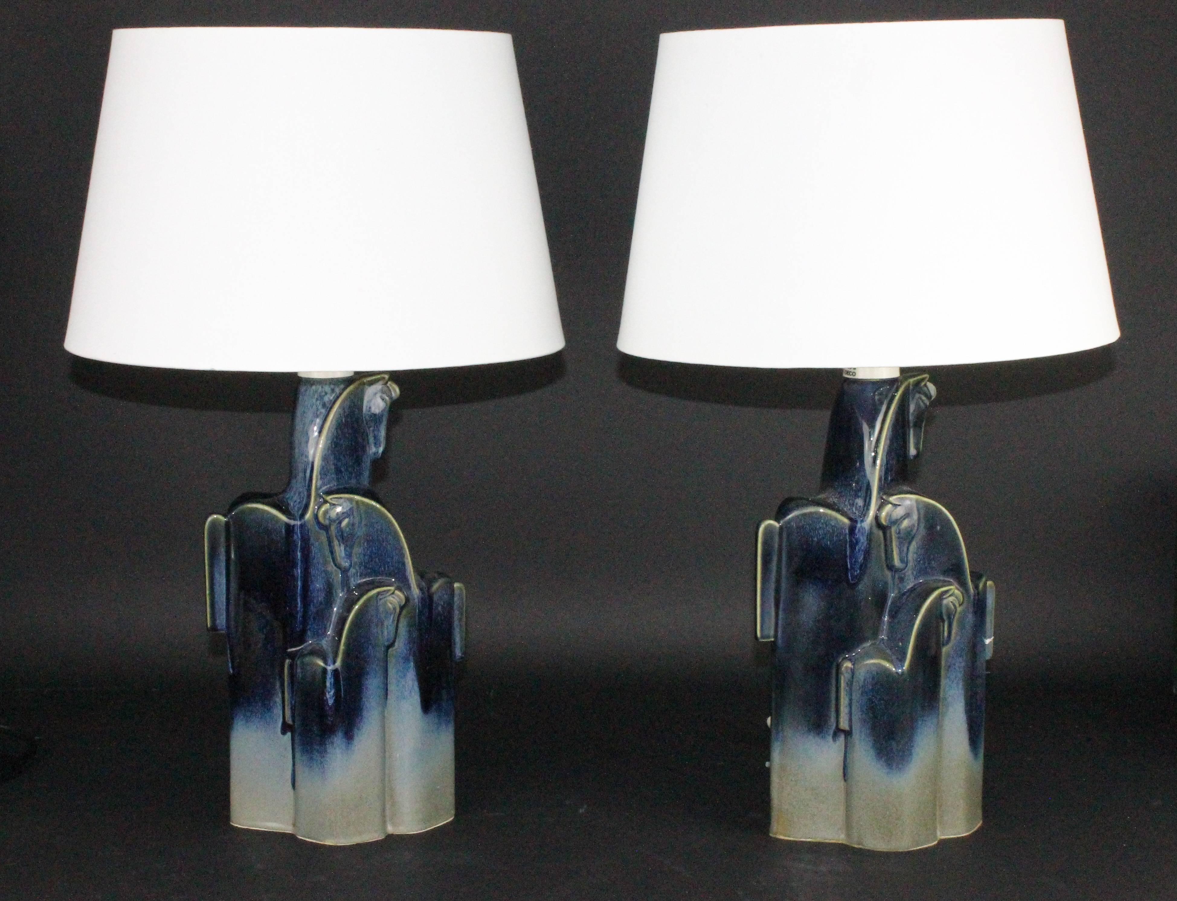 A pair of stunning table lamps by designer Christina Praestgaard. Made in Torekov in the 1970s.
Very unusual to find a pair in perfect condition. The model is called "Wild horses of Pampas".
Height of ceramic 32cm, with these shades 55cm.
