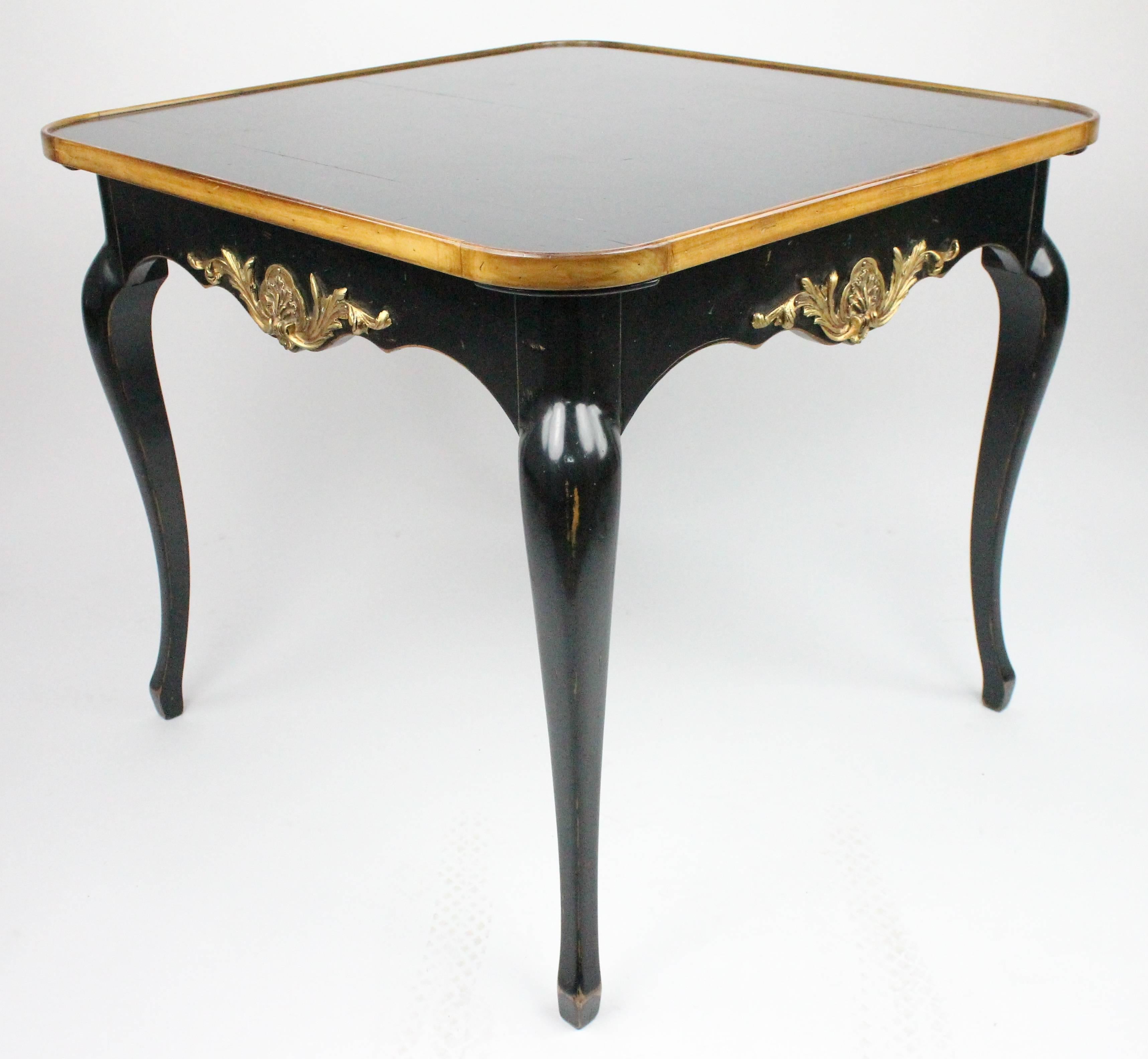 A wonderful card or games table by the French firm Moissonnier.
Fully stamped with manufacturer mark, see images.
The top is reversible, with a red leather top and also a black painted top.
This table is made in the Louis XV style. It is made in