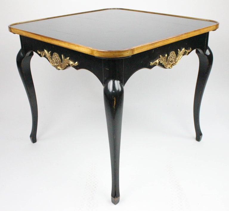 A wonderful card or games table by the French firm Moissonnier.
Fully stamped with manufacturer mark, see images.
The top is reversible, with a red leather top and also a black painted top.
This table is made in the Louis XV style. It is made in