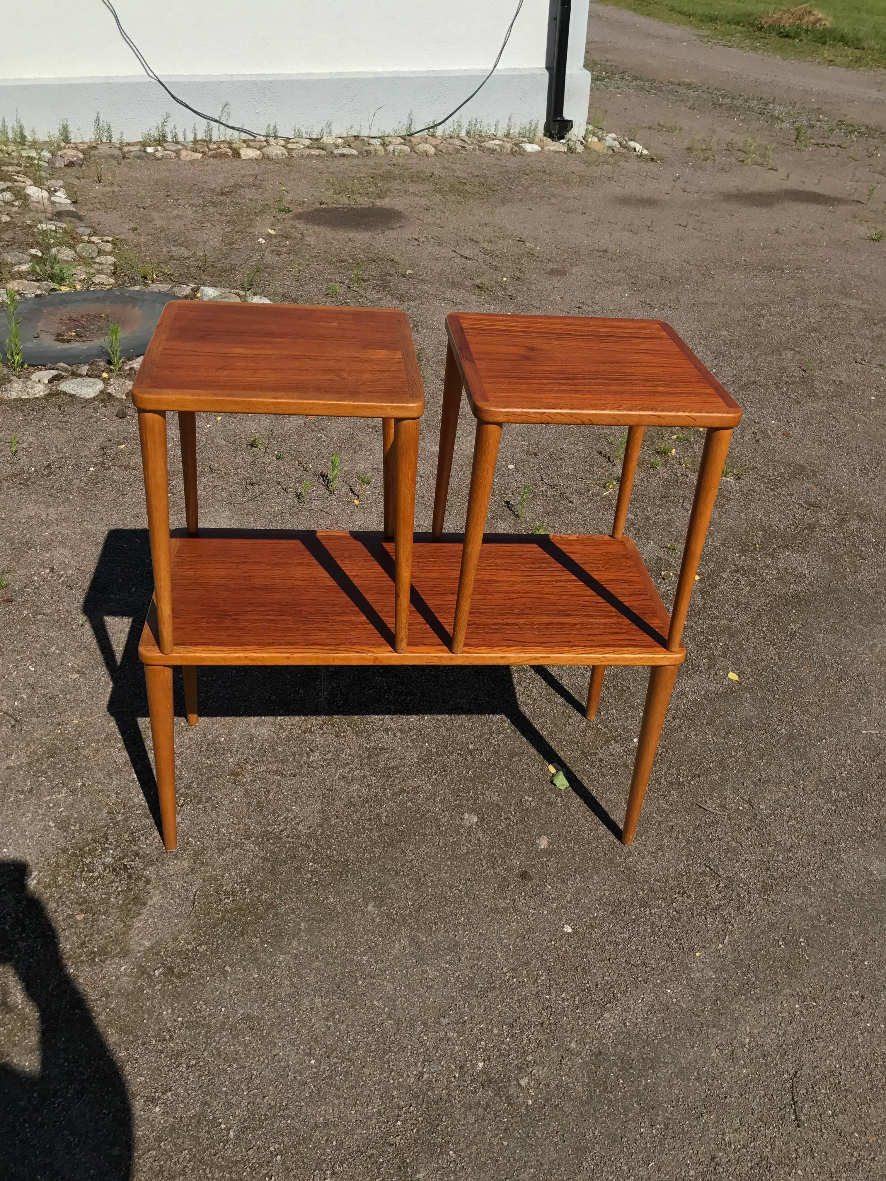 A nice set of three nesting tables in teak and with oak legs. 

Measurement for the small ones is 
13.7 inches 2 and height is 15.3 inches.