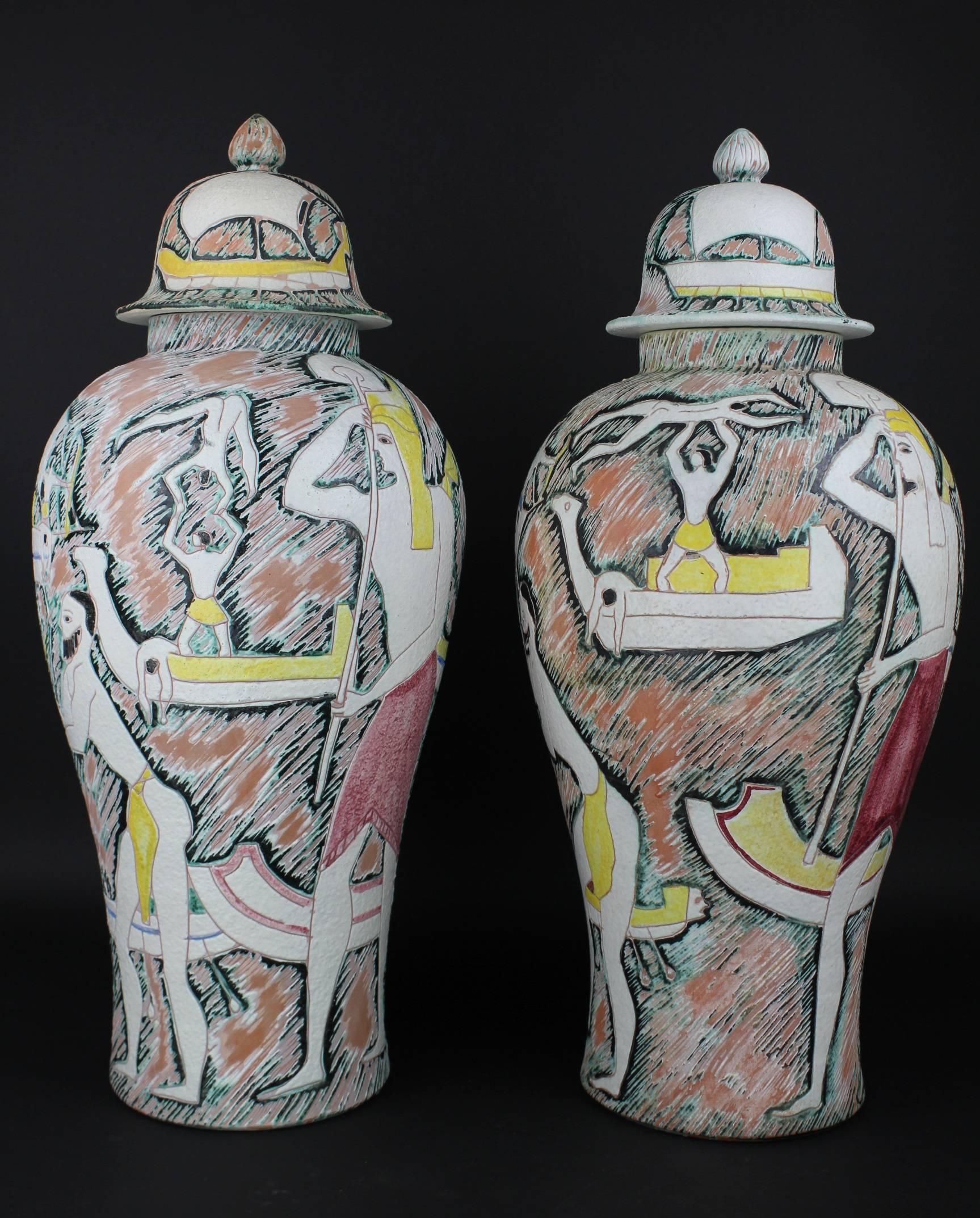 An outstanding pair of vases with covers in the sgraffiti technique by the Italian master Marcello Fantoni. These ceramic masterpieces are in perfect condition and they are both signed. These are made in the Italian Etruscan style. Marcello has used