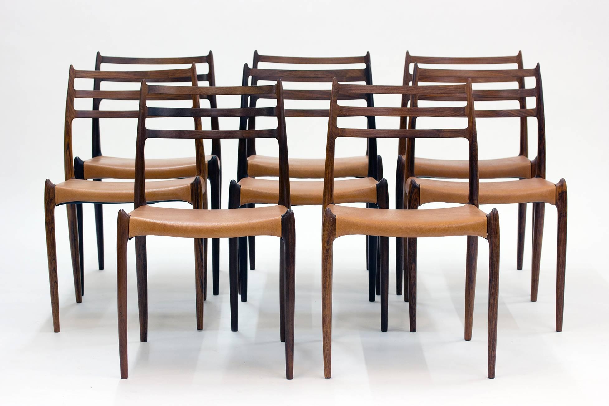 Set of eight gorgeous rosewood dining chairs by Niels O. Møller. Model 78 designed in 1962.  Vintage leather seats in a tan nuance. The fluency of the design and the hornlike details at the seats and on the backrests give these chairs a breathtaking