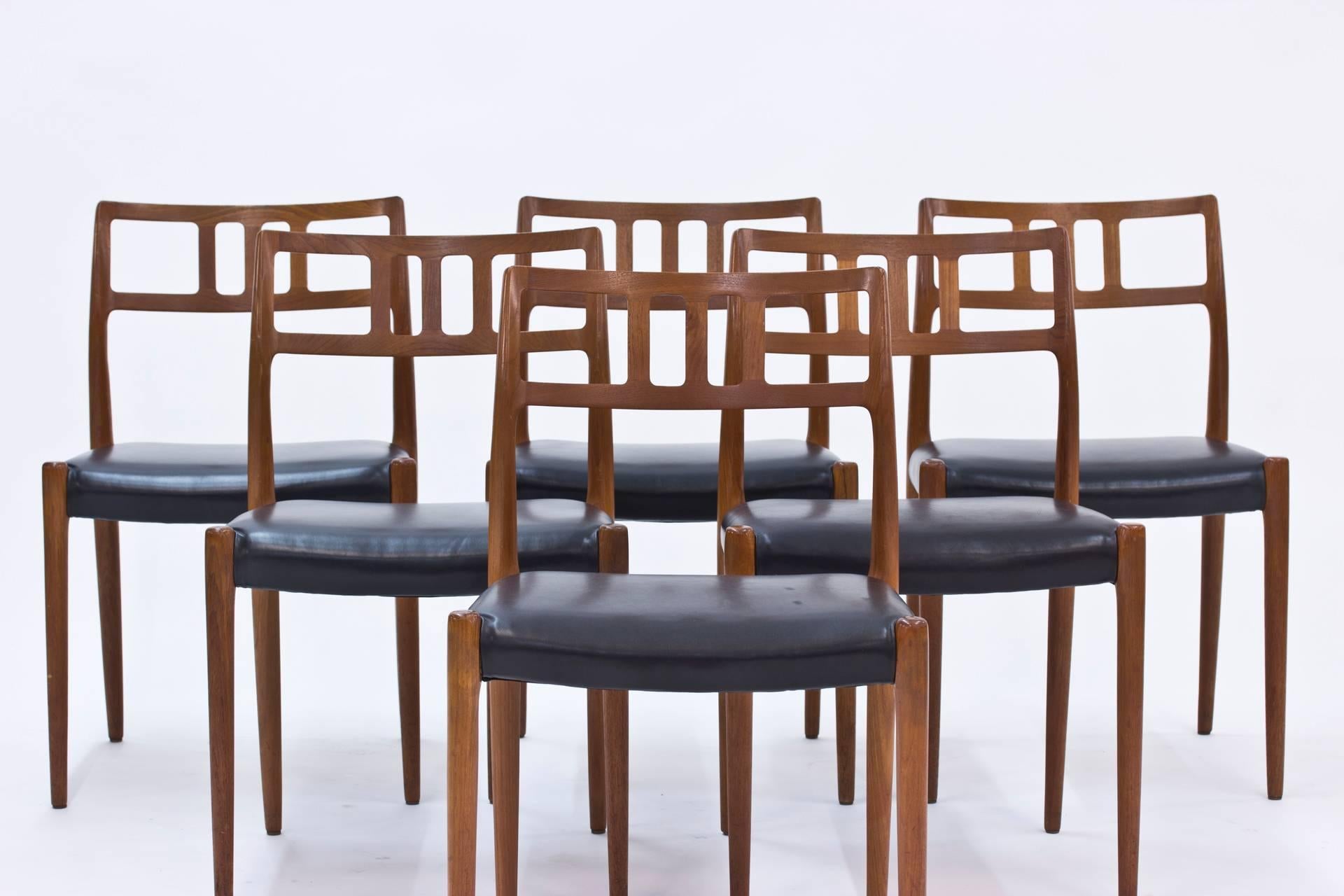 This set of six dining chairs was designed by Niels O. Møller and produced by J. L. Møller during the 1950s in Denmark. It is made from teak with leather seats and remains in excellent vintage condition.