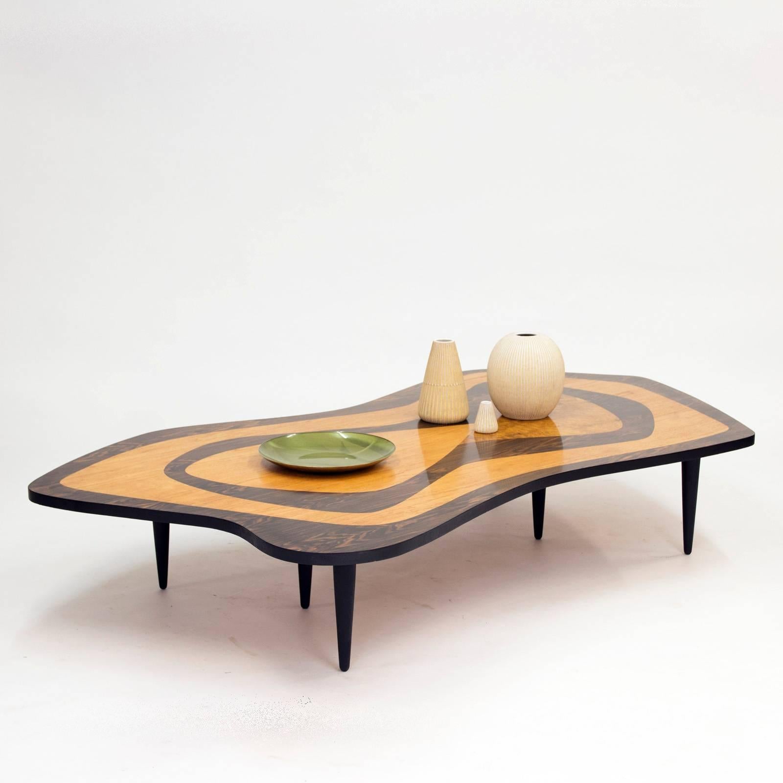 Amazing Swedish 1950s intarsia coffee table, in a remarkable size and design! The organic shaped tabletop has inlays of rosewood, birch root and elm in a striking graphic pattern. Supported by six legs.