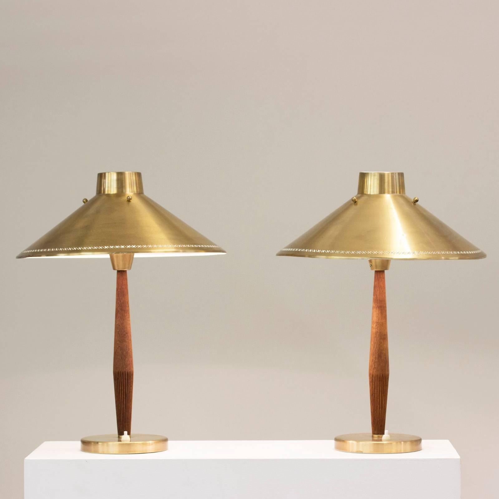 Pair of beautiful table lamps by Hans Bergström for ASEA, with teak poles with a pattern of carved slits and brass shades with a punched-out pattern around the edges.

The architect Hans Bergström founded the lighting firm Ateljé Lyktan in Åhus in