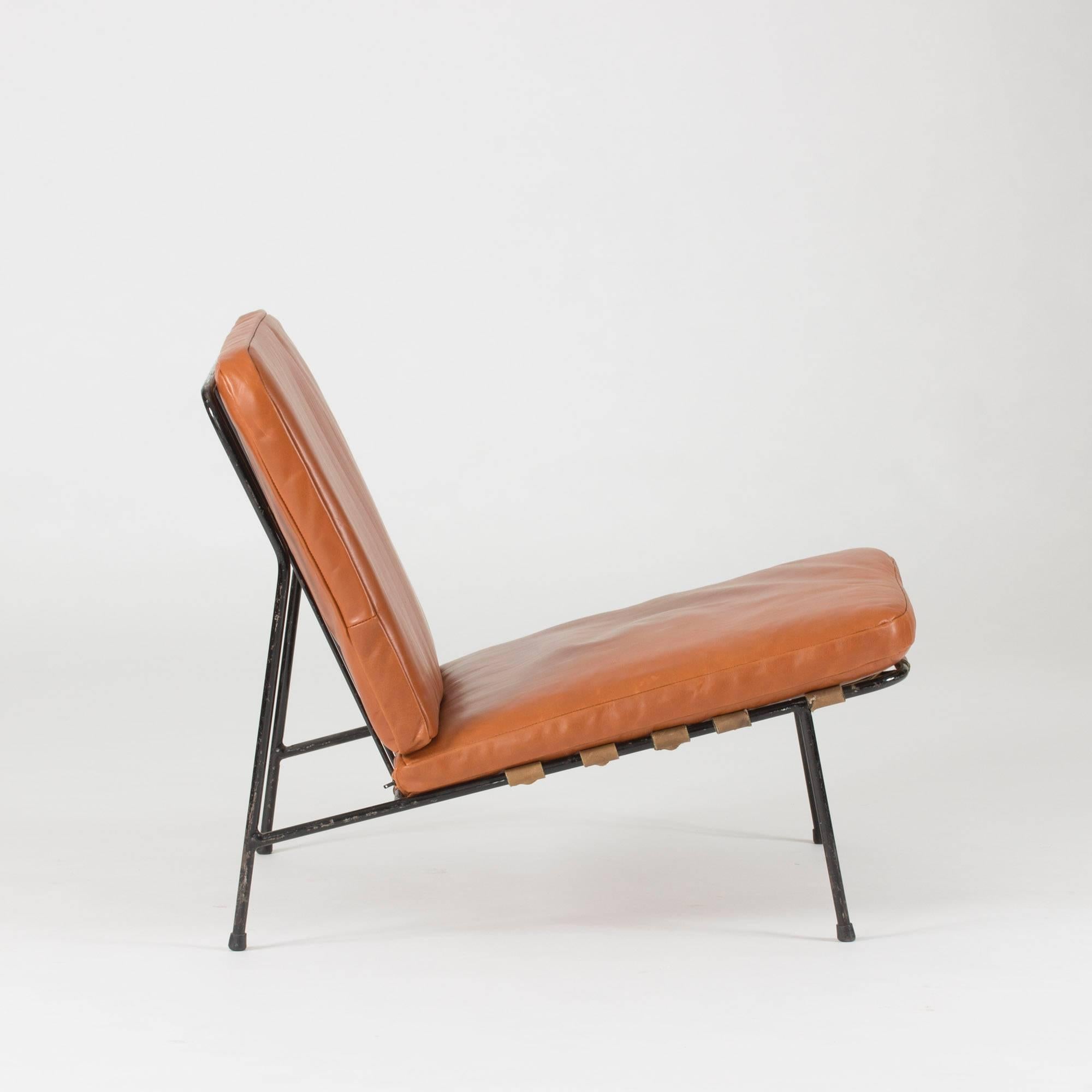 Lounge chair by Alf Svensson for Ljungs industries, later known as DUX, made in the 1950s. Black lacquered steel frame with removable cushions upholstered in luxurious cognac colored leather.

This model was first introduced at the iconic