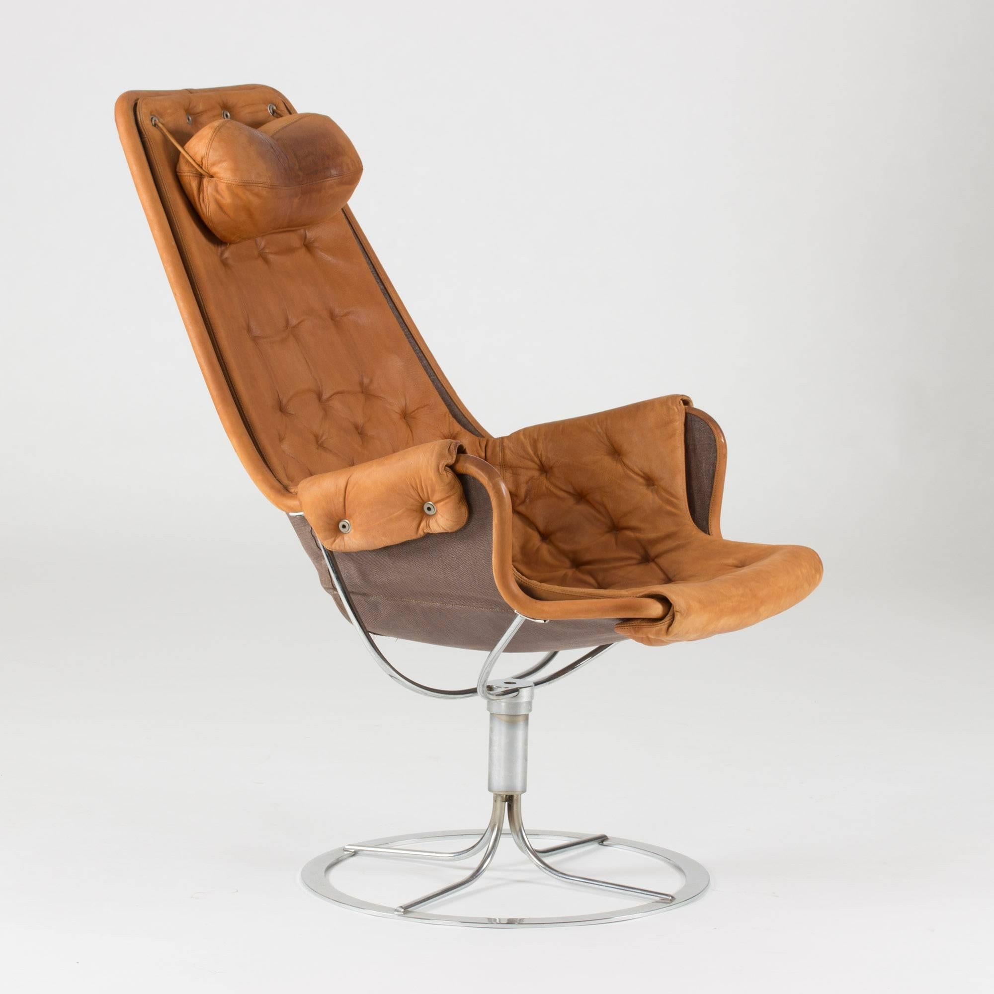 Iconic, timeless “Jetson” swivel lounge chair by Bruno Mathsson, designed in 1965, however this particular chair was produced during the 1970s. Canvas and cognac leather on a steel frame.