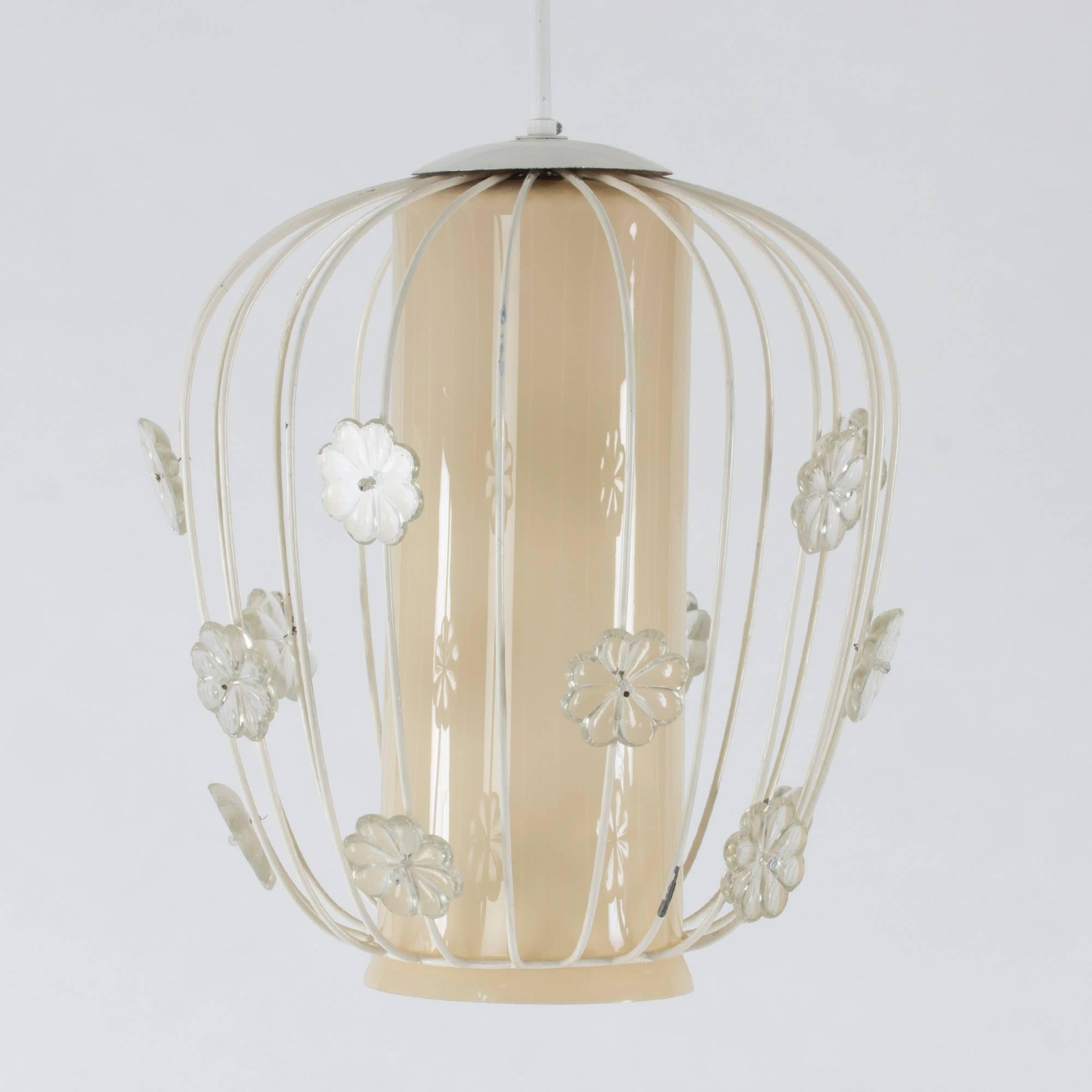 Beautiful 1950s ceiling lamp with a glass center enclosed by an off-white lacquered cage with appliqued glass flowers around the body.