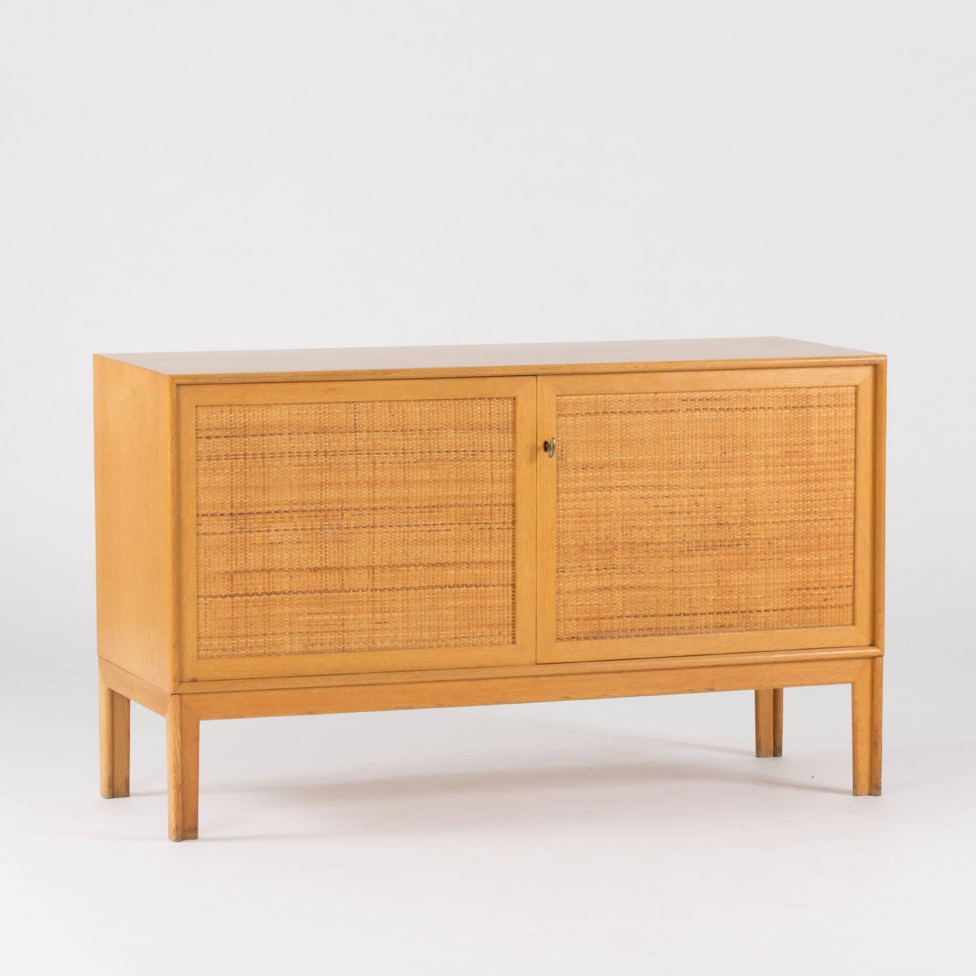 Oak sideboard with beautiful rattan fronts, designed by Alf Svensson for Bjästa. Two drawers inside on each side of a separating section. Nicely sculpted legs.