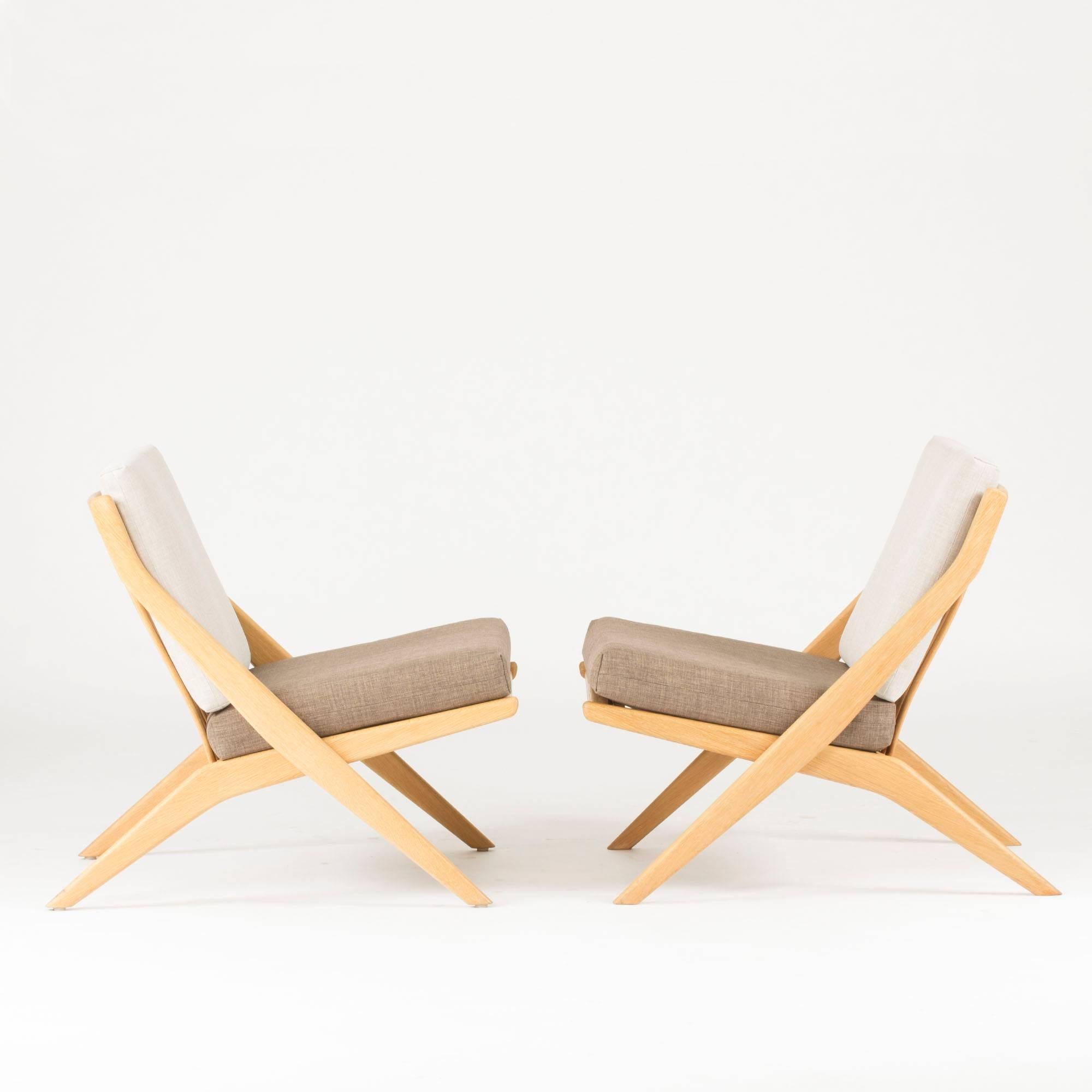 Pair of lounge chairs by Folke Ohlsson for Bodafors, made from oak with removable cushions. Casual, comfortable elegance beautifully executed.