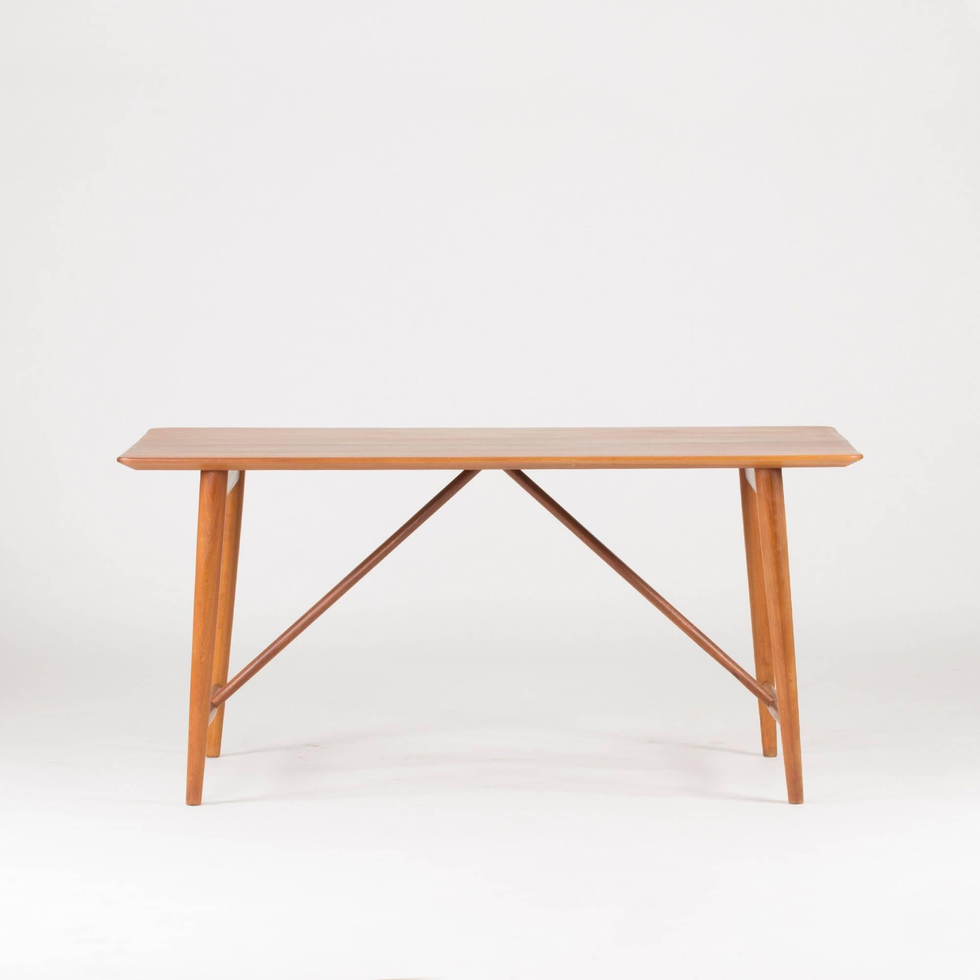 Beautiful solid teak desk by architect pair Peter Hvidt and Orla Møllgaard. Sculptural legs and striking tabletop with a striped pattern. Great execution.