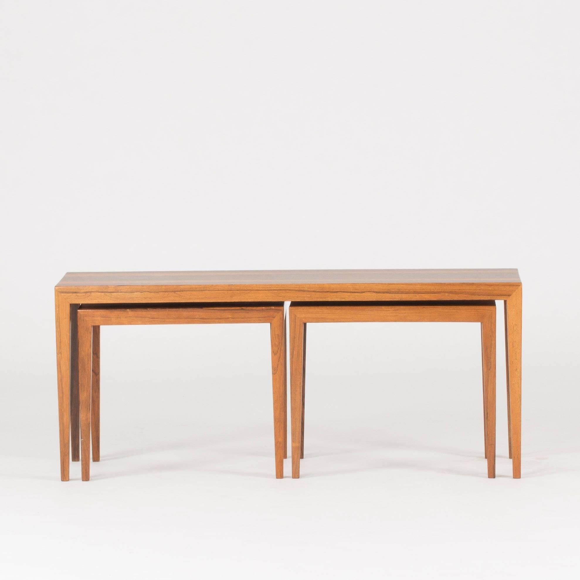 Long, elegant rosewood nesting table by Severin Hansen. Two smaller tables are set next to each other under the long upper table. Beautiful veneer.

The sizes of the small tables are as follows:

Height 41.5 cm
Width 49 cm
Depth 31.5 cm.