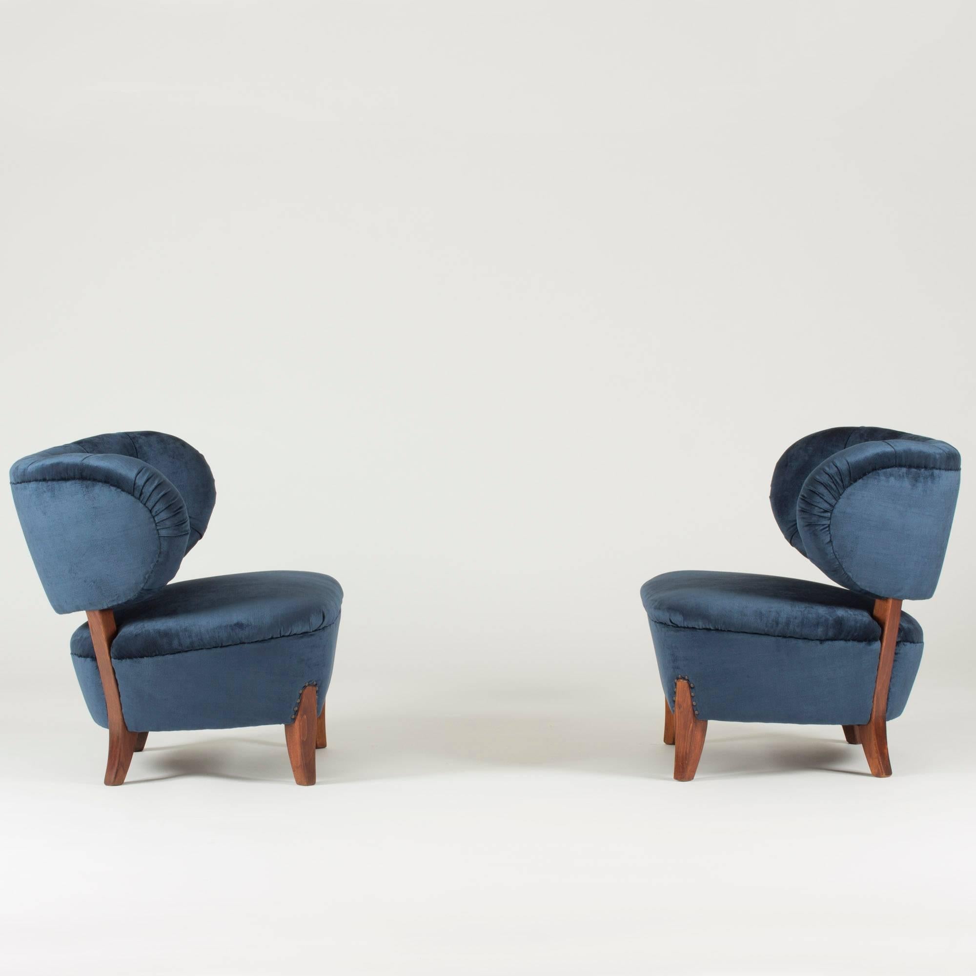 Pair of beautiful lounge chairs by Otto Schulz, upholstered with midnight blue velvet and decorated with decorative nails around the back legs.