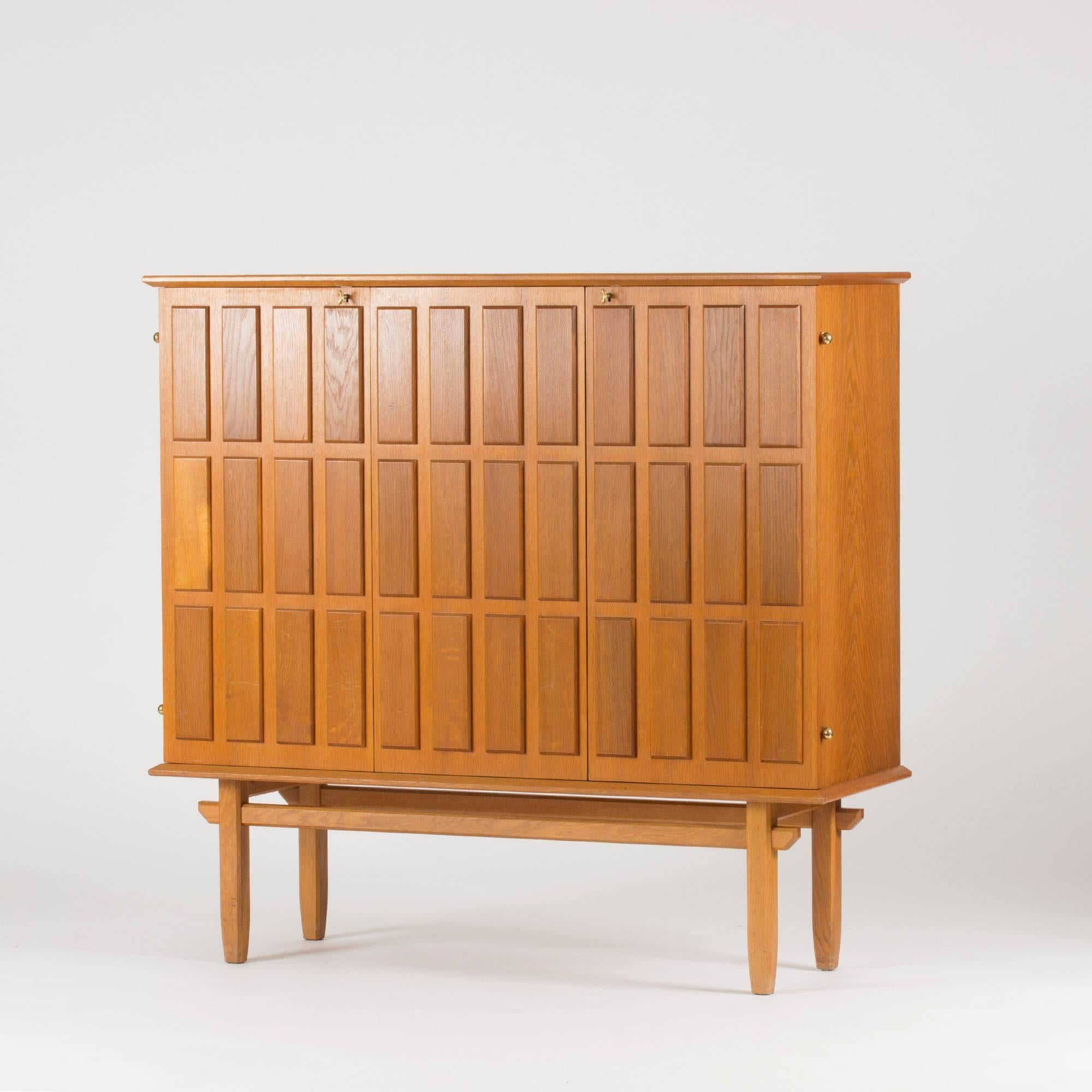 Mahogany cabinet by Eyvind Beckman with a striking, deep relief pattern of large rectangles. Subtle, elegant details, protruding brass hinges.