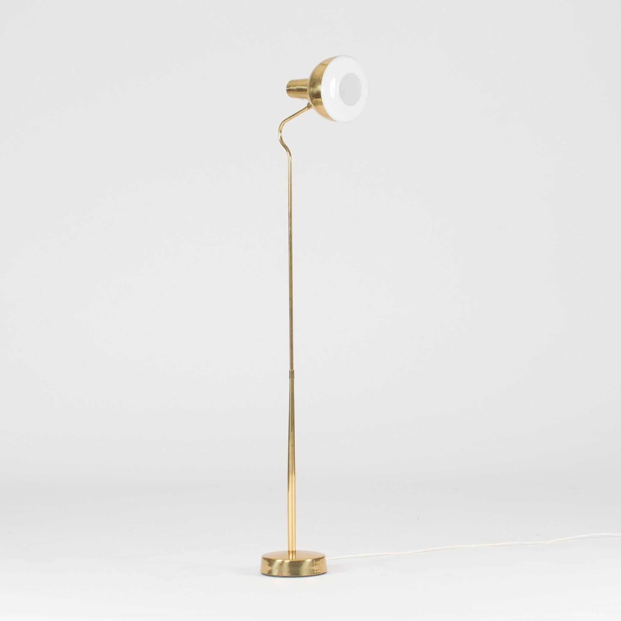 Brass floor lamp from ASEA in a simplistic design with elegant curves.
