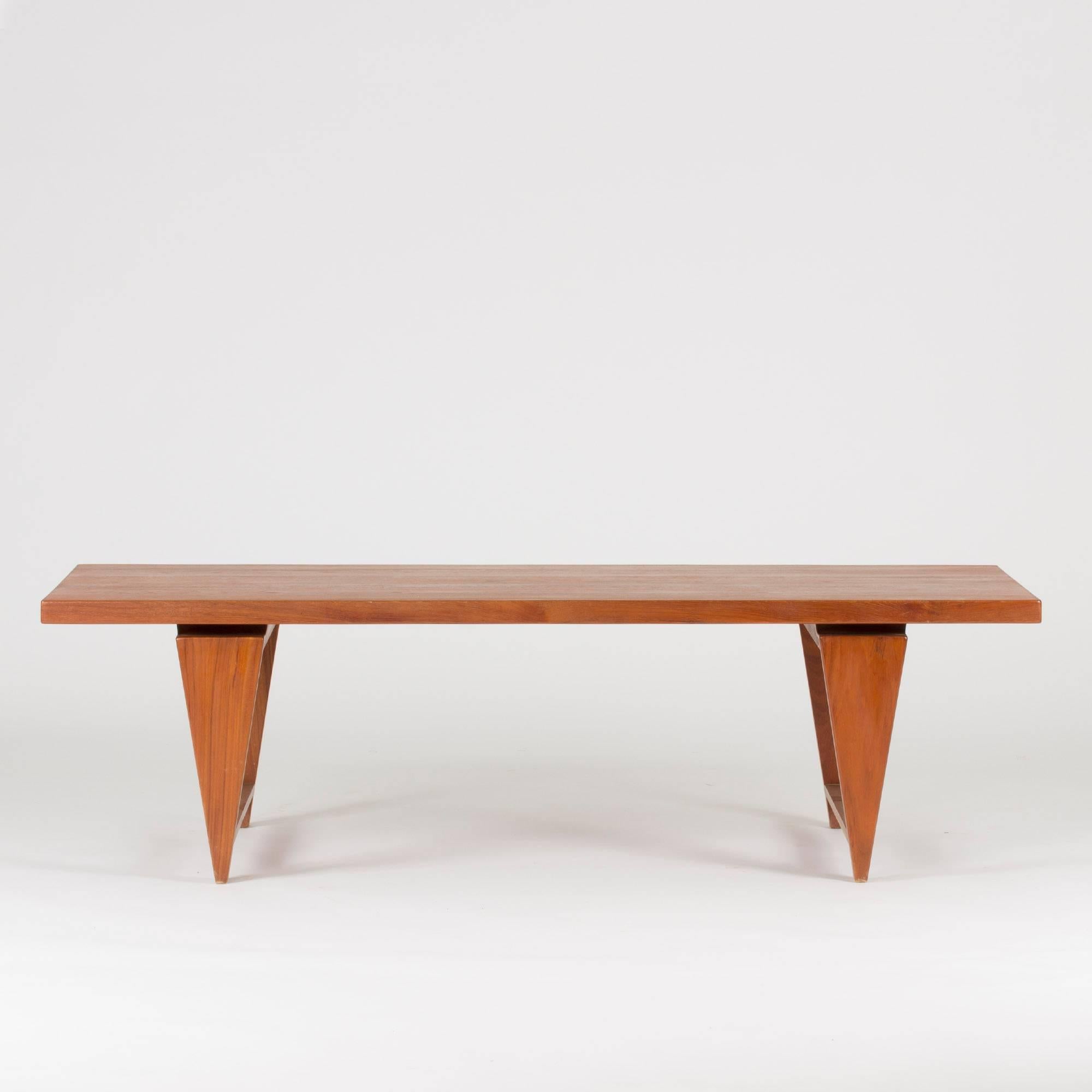 Coffee table by Illum Wikkelsø made from solid teak. Edgy details and a tabletop that seems to hover just above the base.